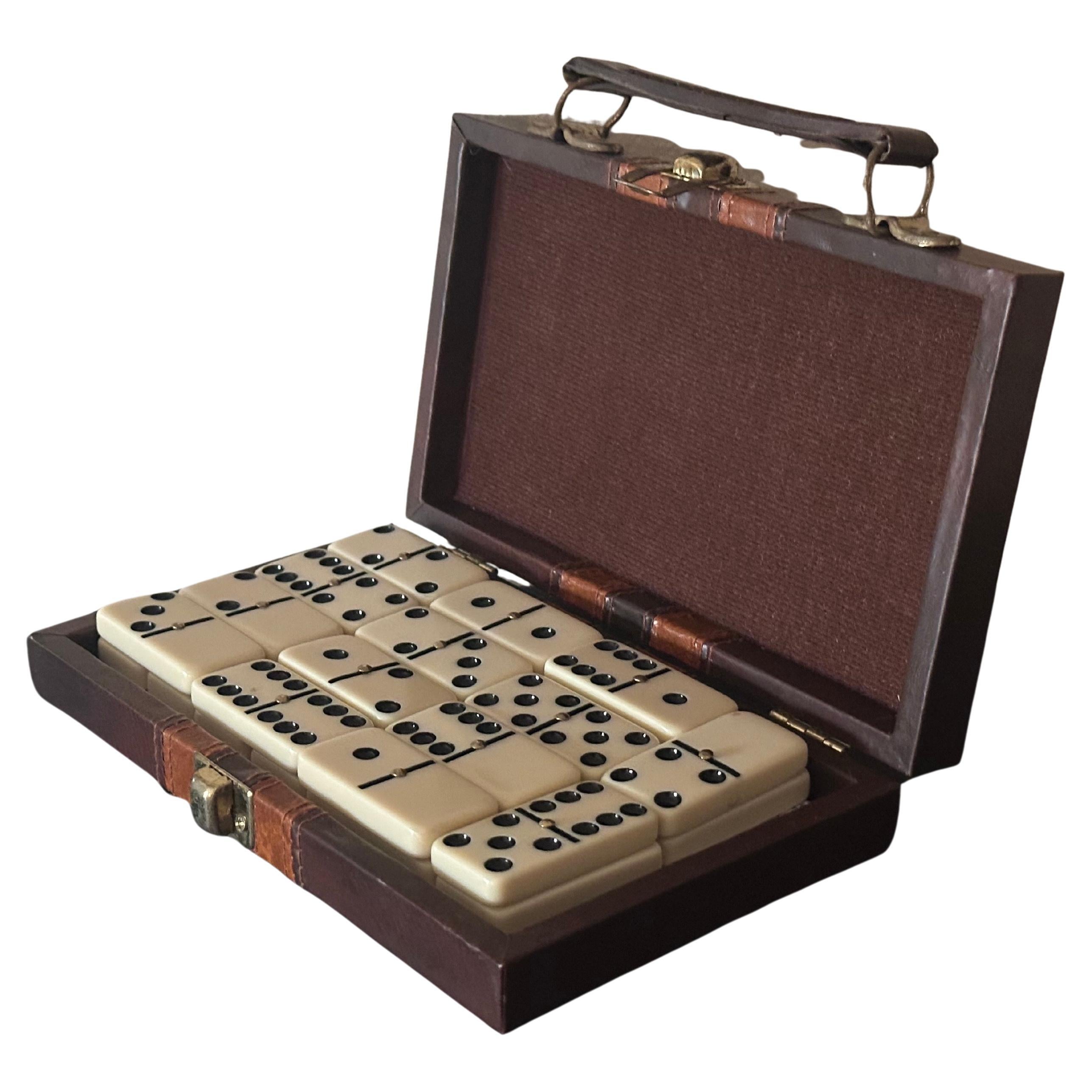 Vintage MCM travel domino set in miniature briefcase, circa 1970s.  A very cool domino set in a brown and tan striped faux leather case with 28 dominoes and the original instruction sheet. The set is in very good vintage condition and measures 4.5
