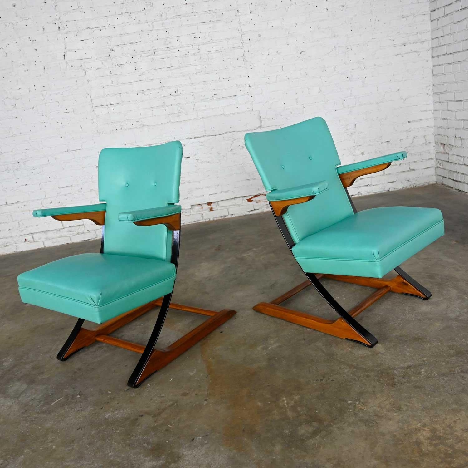Fantastic pair of Mid-Century Modern turquoise vinyl or faux leather spring rockers style of McKay Furniture and Rock-A-Chair. Comprised of the original turquoise vinyl or faux leather, a wood frame, and black painted metal springers. Beautiful