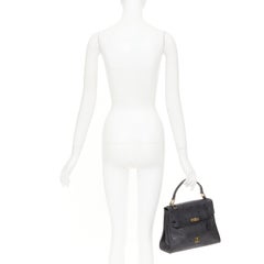 Sac à main MCM Vintage Kelly en nylon à motif Visetos, bordures en cuir et fermeture à tourlock, avec poignée sur le dessus