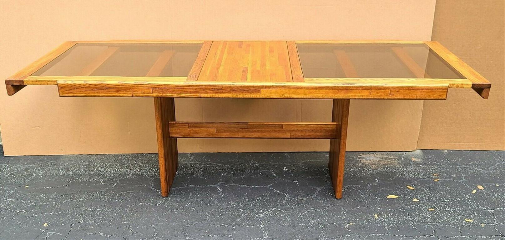 Offering one of our recent palm beach estate fine furniture acquisitions of a
MCM vintage solid teak smoked glass extendable with pop up leaf dining table

Approximate measurements in inches
Width: 88.75