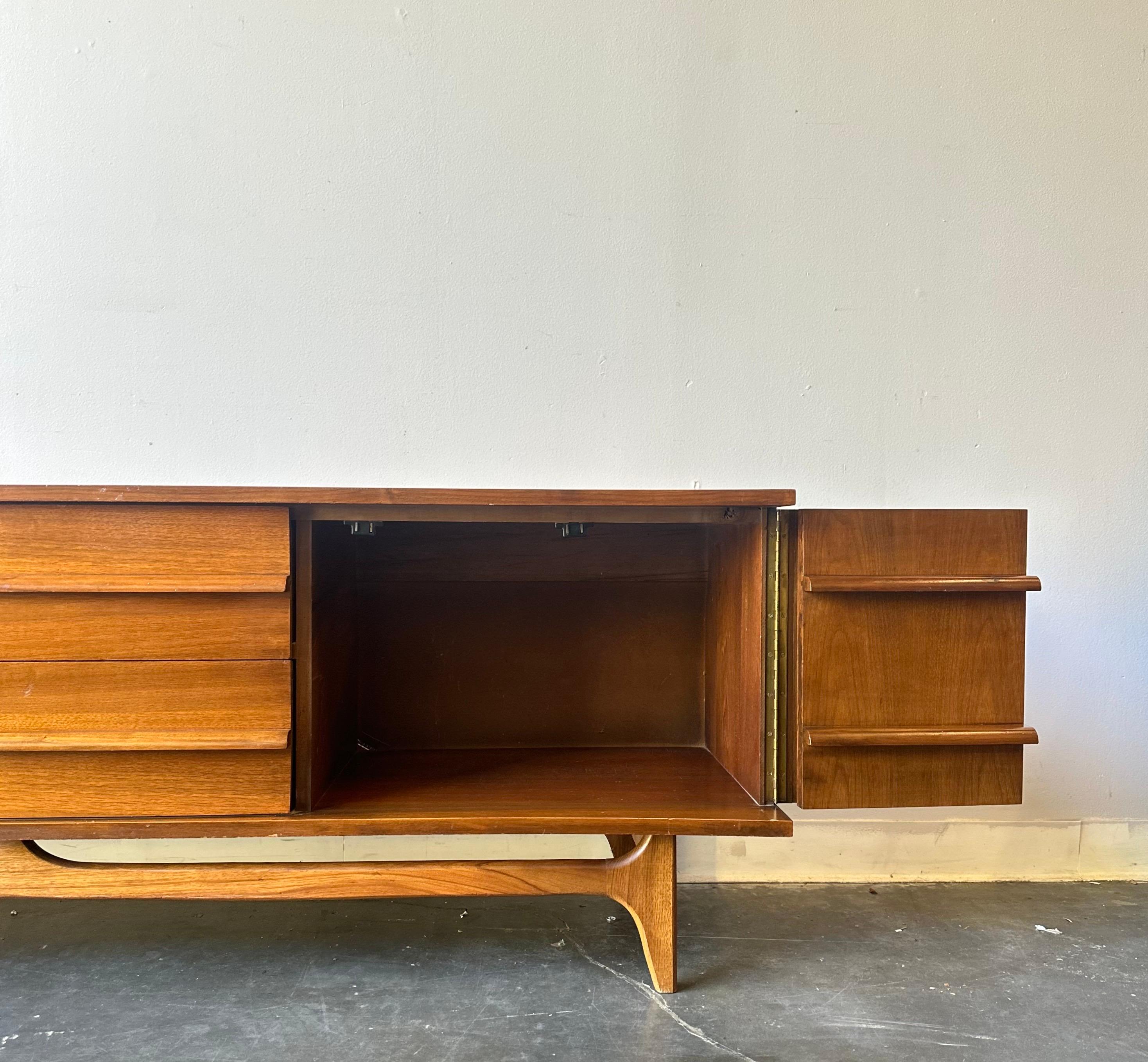 American MCM Walnut low sculptural credenza by young , circa 1960