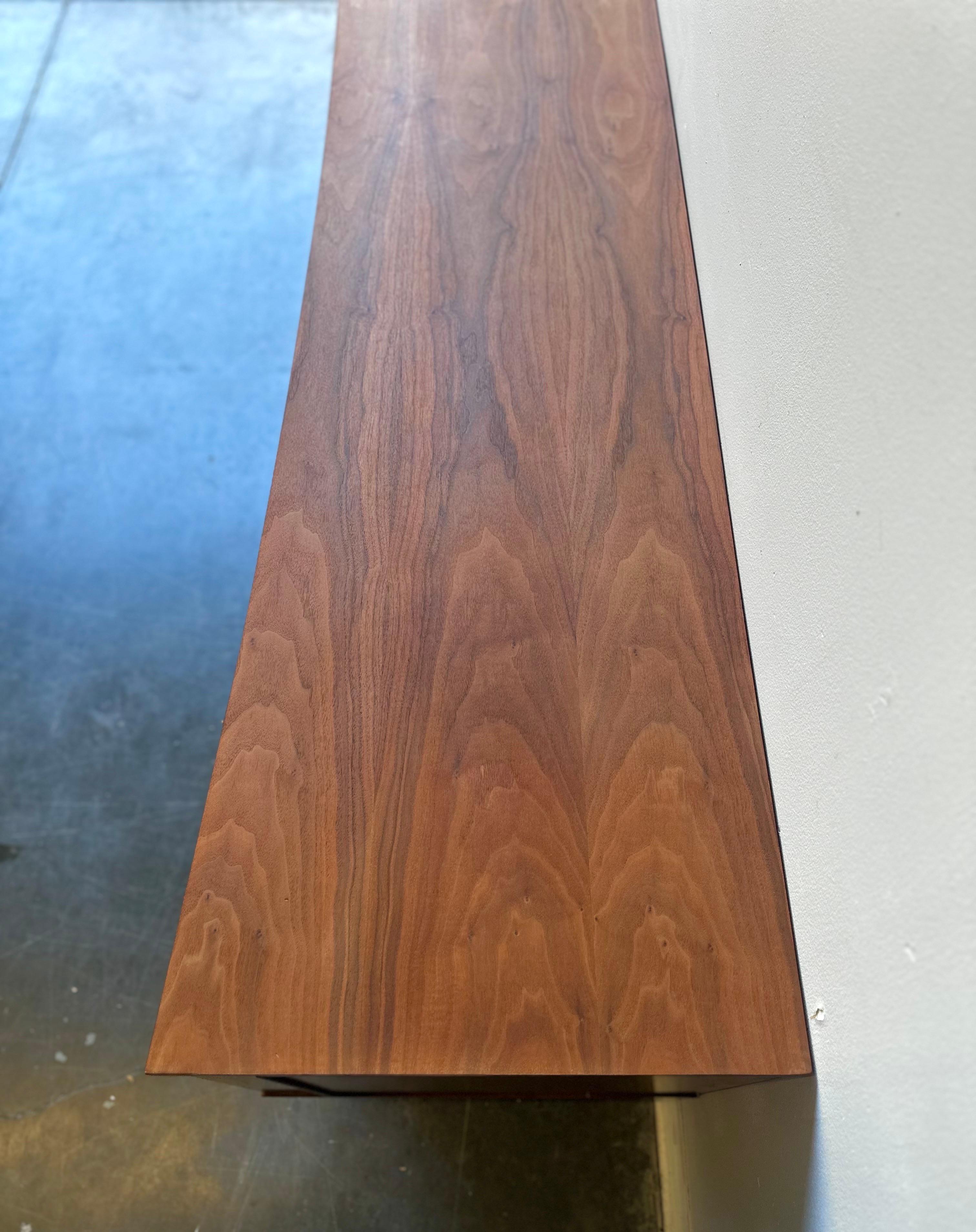 Woodwork MCM Walnut low sculptural credenza by young , circa 1960