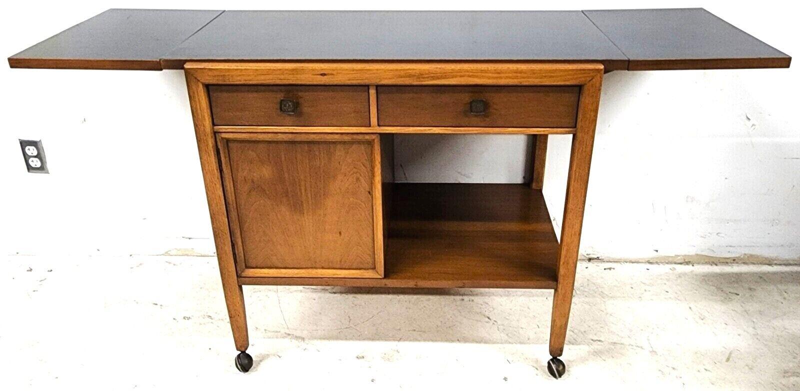 For FULL item description be sure to click on CONTINUE READING at the bottom of this listing.

Offering one of our recent palm beach estate fine furniture acquisitions of a vintage MCM walnut rolling sideboard buffet bar cart by