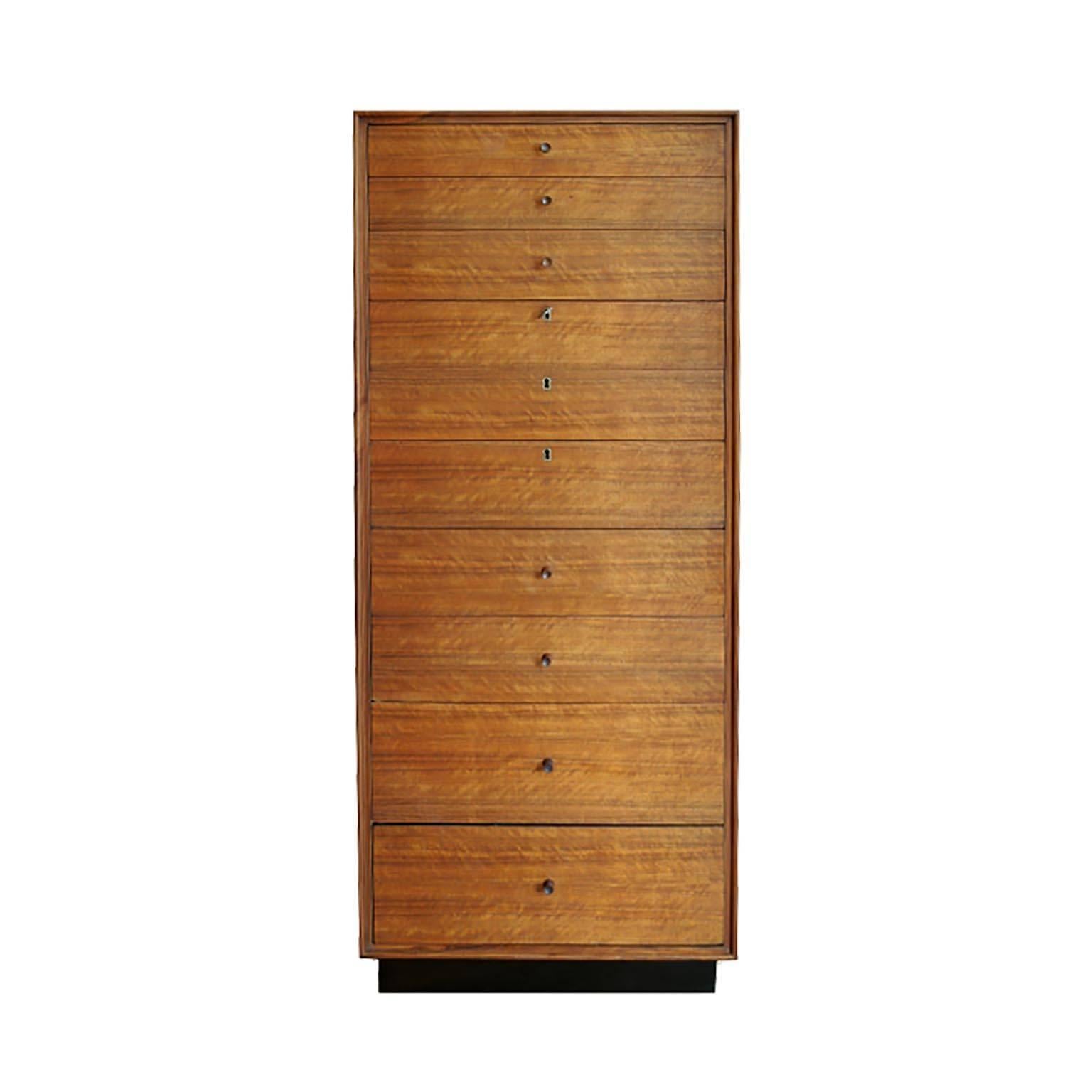 Chest of drawers with ten graduated drawers and original black plinth on the base. Three drawers are keyed with original key. Designed by Kipp Stewart and Stewart McDougall, circa 1950s.