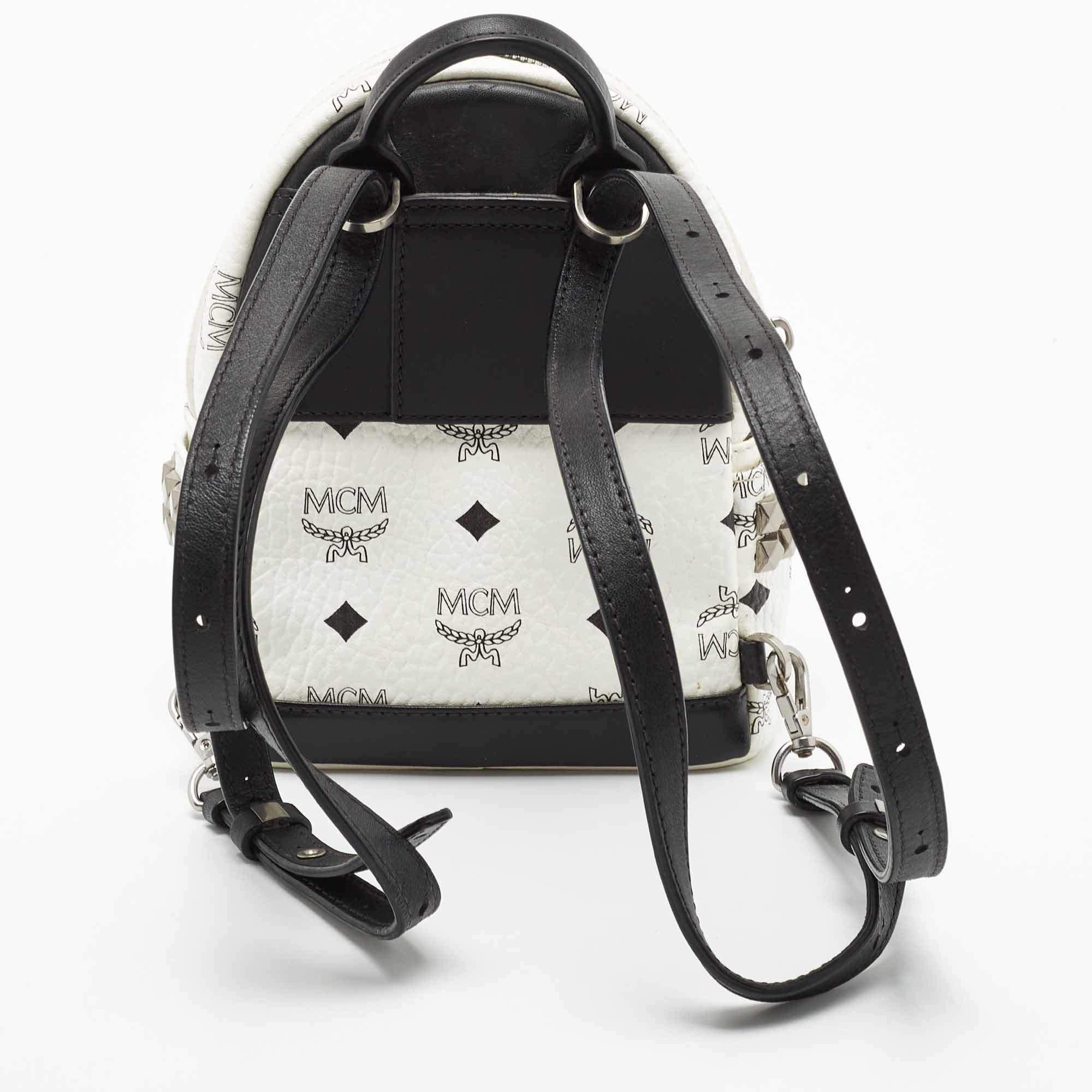 This MCM Stark-Bebe Boo backpack will come in handy for daily use or as a style statement. It is crafted from white/black Visetos-coated canvas & leather. It features a front zip pocket and a slip pocket on the sides.

