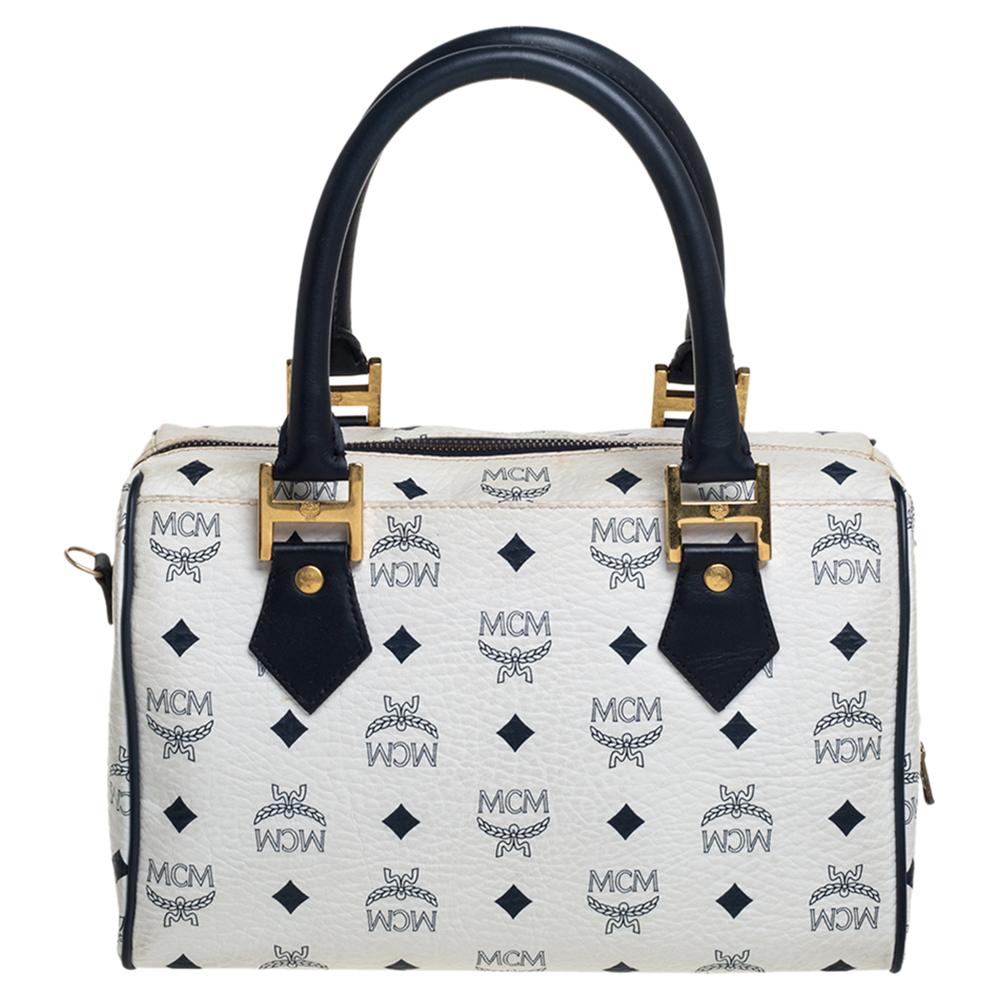 Add the MCM charm to your closet with this Heritage Boston bag. Skillfully made using signature Visetos leather, it can easily hold all your everyday essentials. This MCM white bag is complemented by gold-tone hardware and equipped with two handles