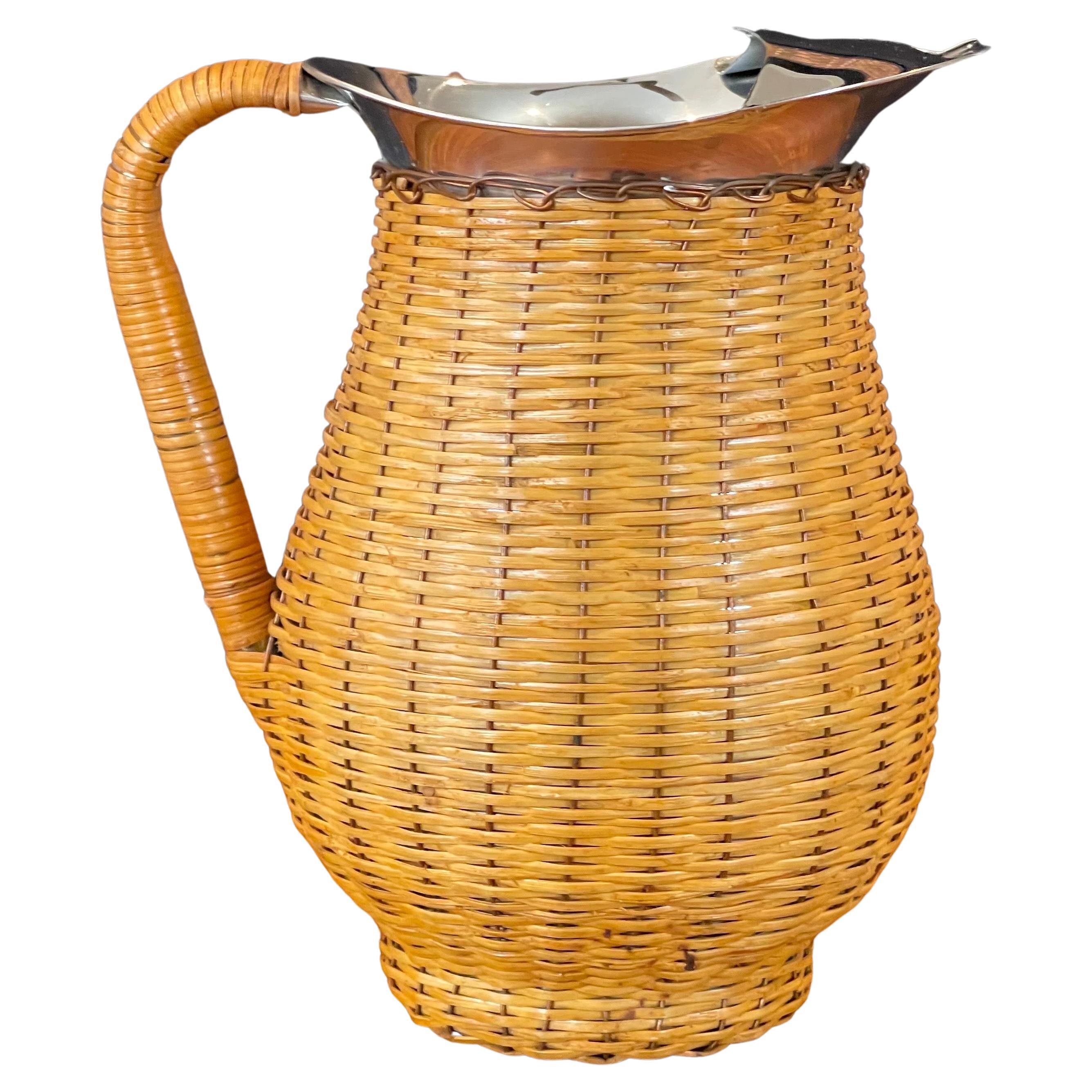 A really nice and well crafted MCM wicker wrapped stainless steel pitcher, circa 1970s. The piece is in good vintage condition and measures 8