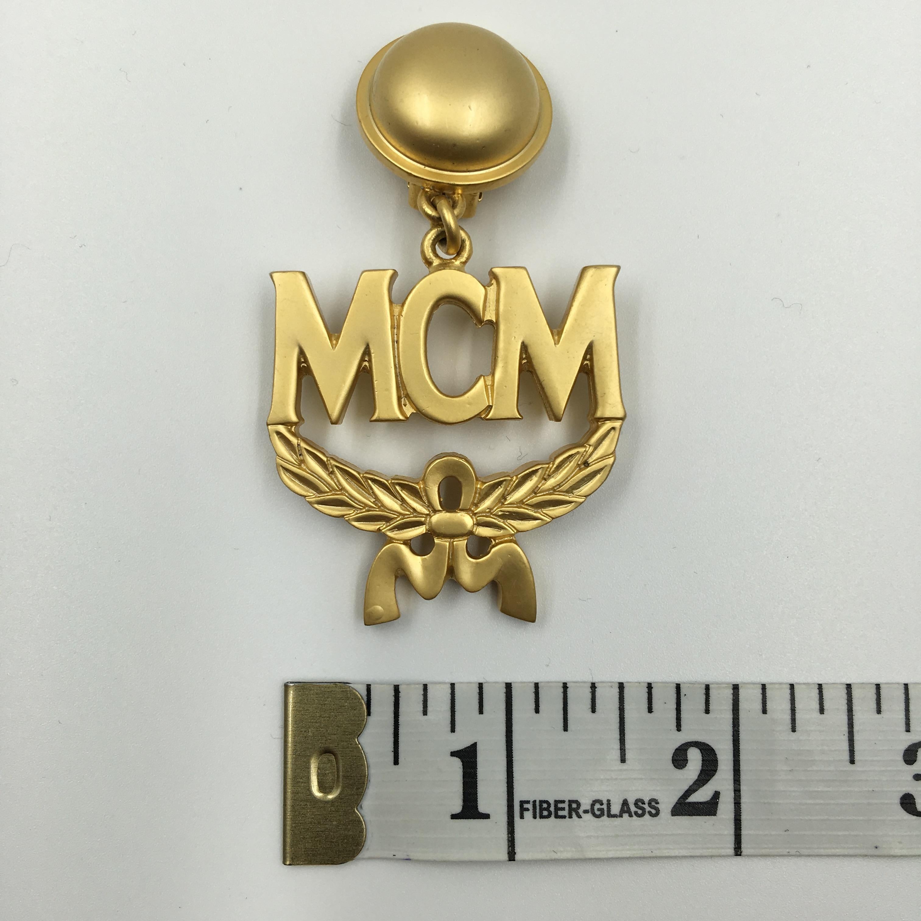 Contemporary MCM Wreath Logo Matte Gold Tone Clip On Earrings For Sale