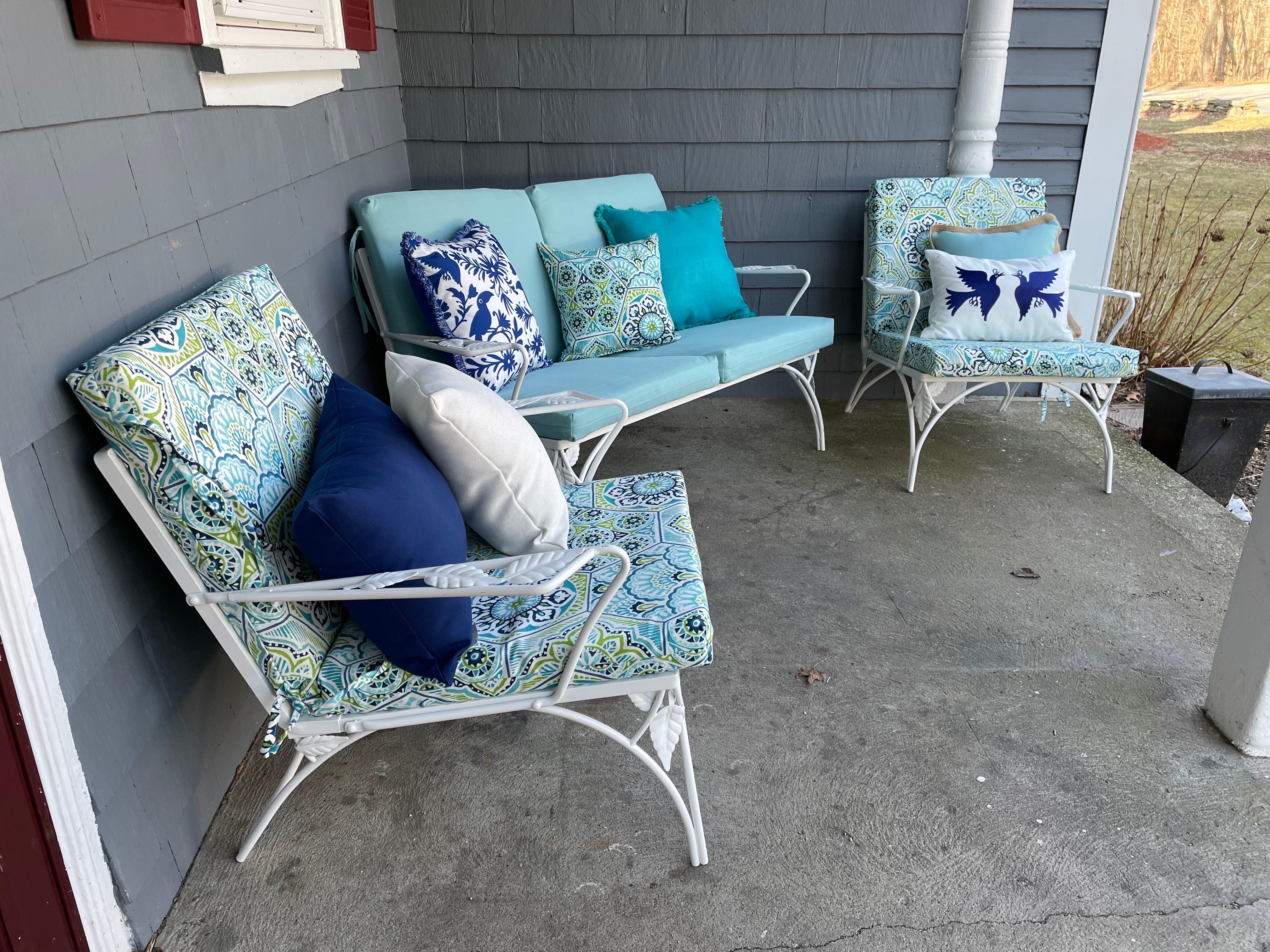 MCM Wrought Iron Outdoor Patio Furniture -A set

(1) 2 Person Loveseat Settee
(2) Arm Chairs 
(4) Pale Blue Outdoor Cushions
(6) Throw Pillows

A stylish set well appointed with a variety of relaxing blue hues to accommodate any pool, patio, garden,