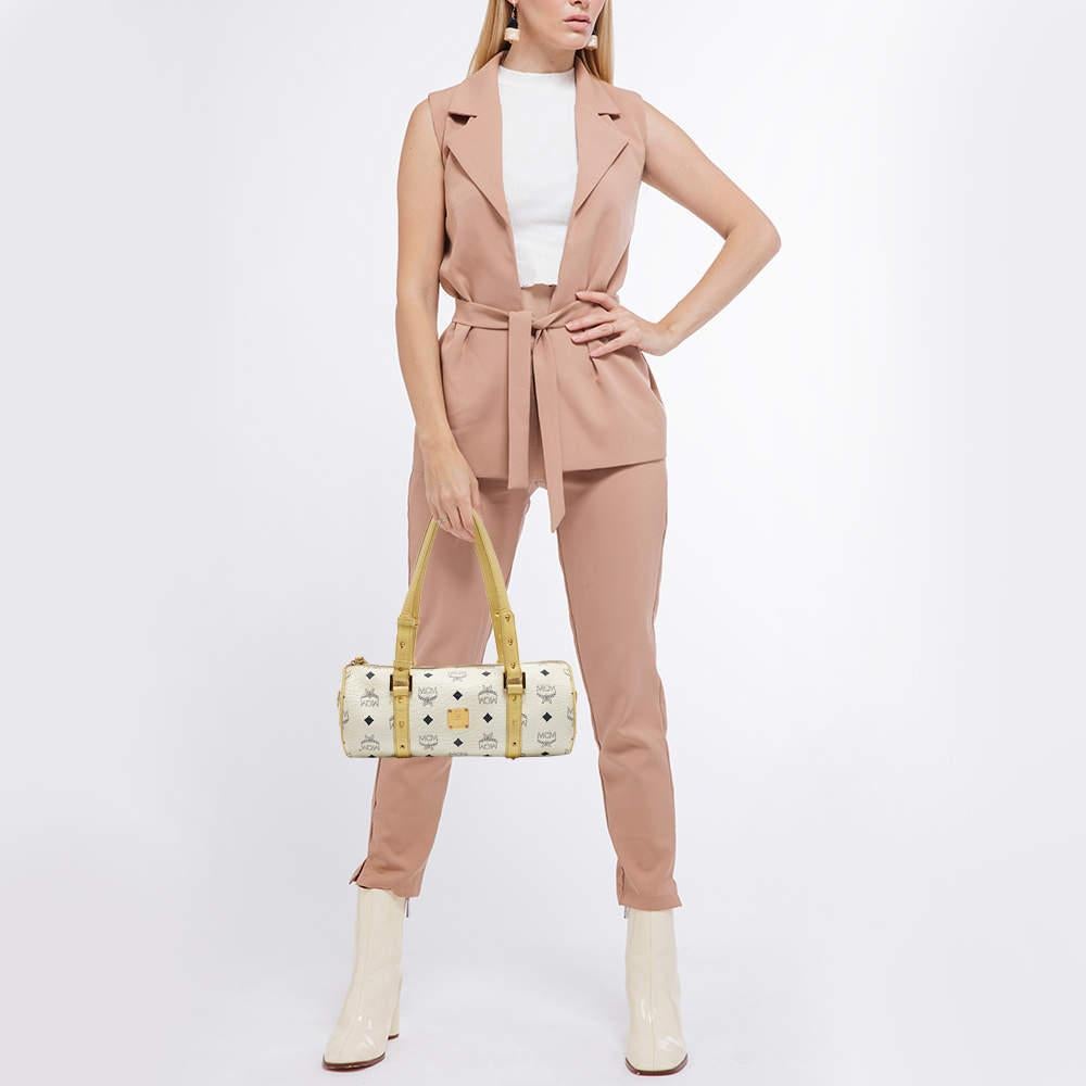 Indulge in timeless luxury with this MCM bag. Meticulously crafted, this iconic piece combines heritage, elegance, and craftsmanship, elevating your style to a level of unmatched sophistication.