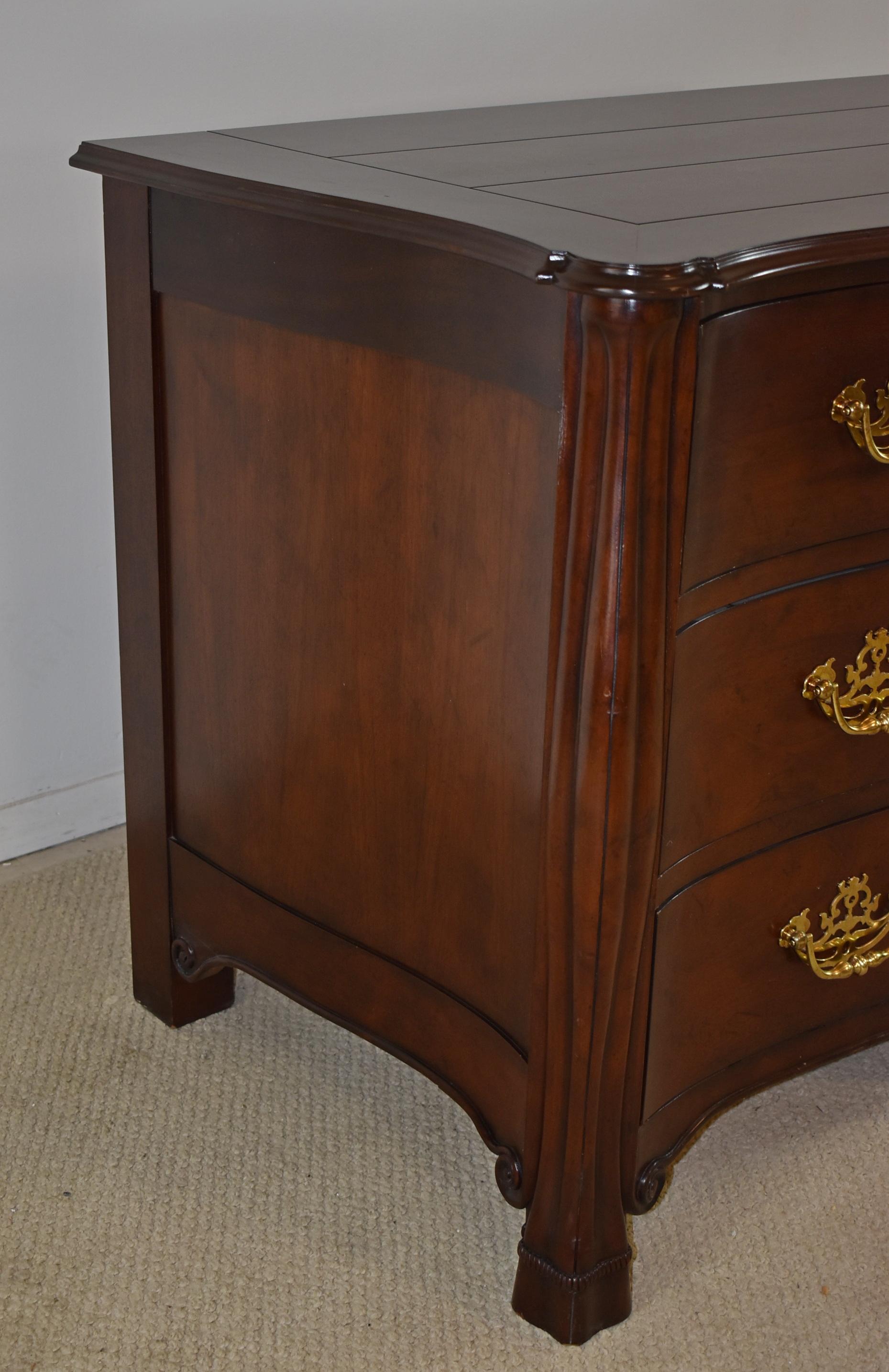 McMillen Collection Chippendale mahogany chest by Baker Furniture. Serpentine bombe Louis XV style with brass hardware. Minor surface wear to top. 50