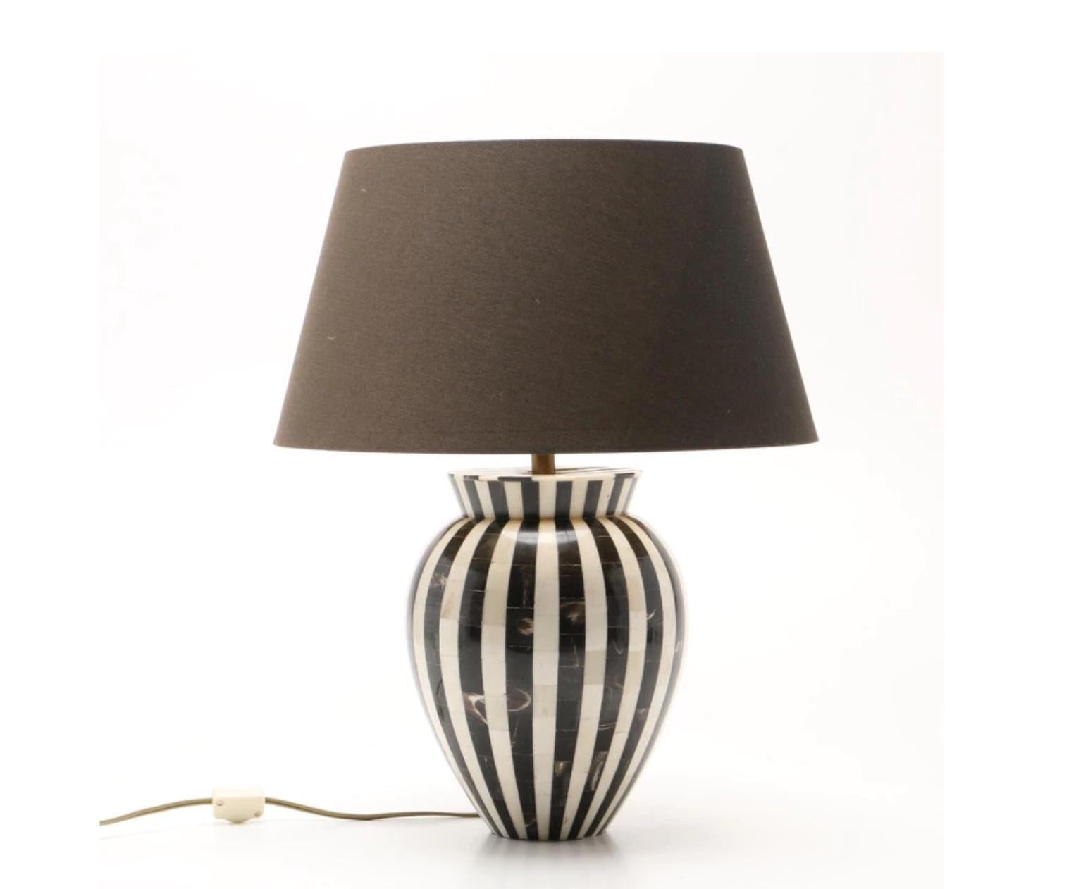 An amazingly stunning one-of-a-kind Mid-Century Modern, most likely French, pair of table lamps-variegated black horn and beige striped camel bone inlay in a vertical stripe pattern, each having a linen shade. The single bronze tone socket lamps