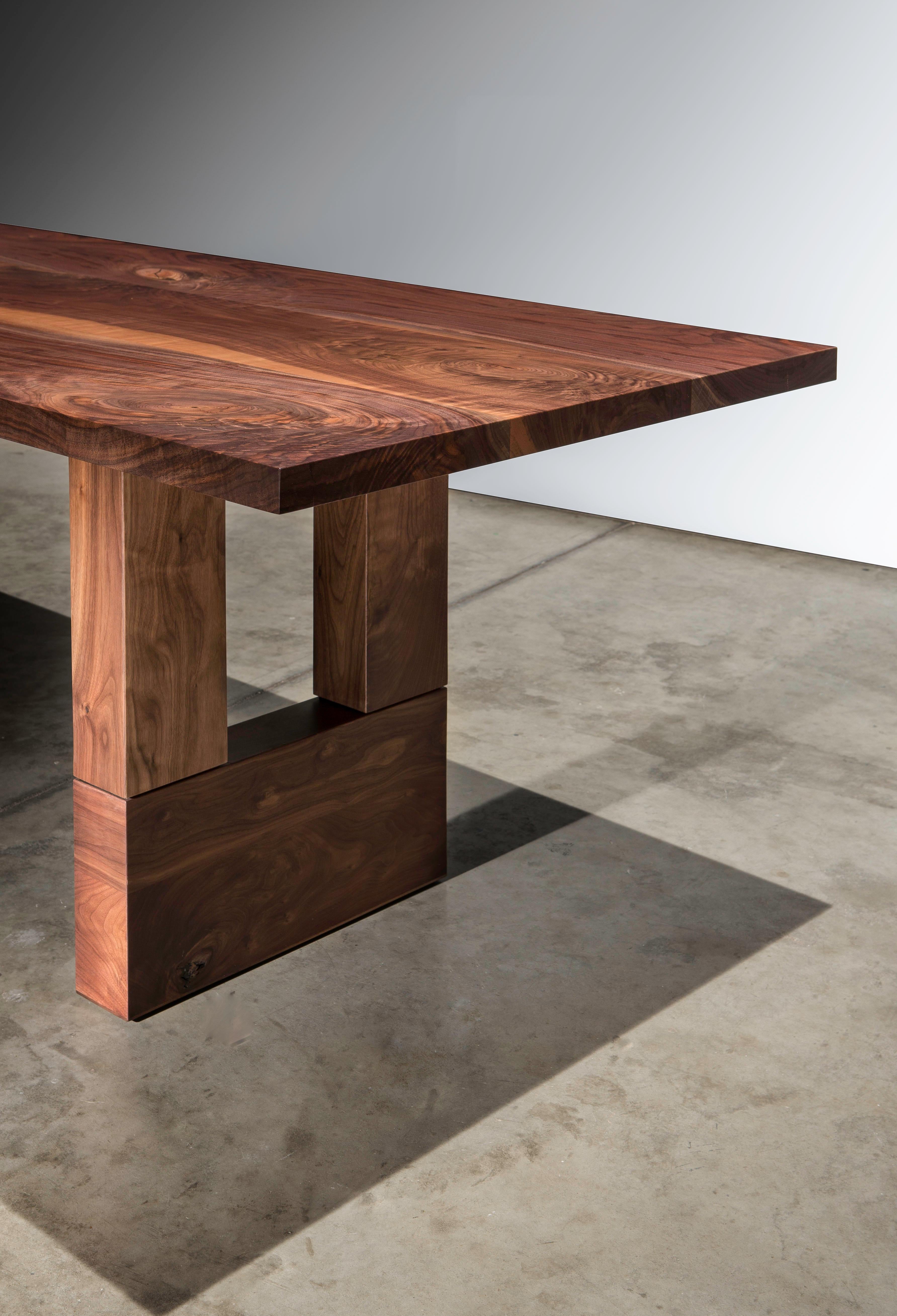 The McNichols dining table is made of a solid walnut board top that has been hand-selected to show off the natural beauty and character of the black walnut. The tabletop is set on solid walnut legs. The legs are made to keep the table structurally