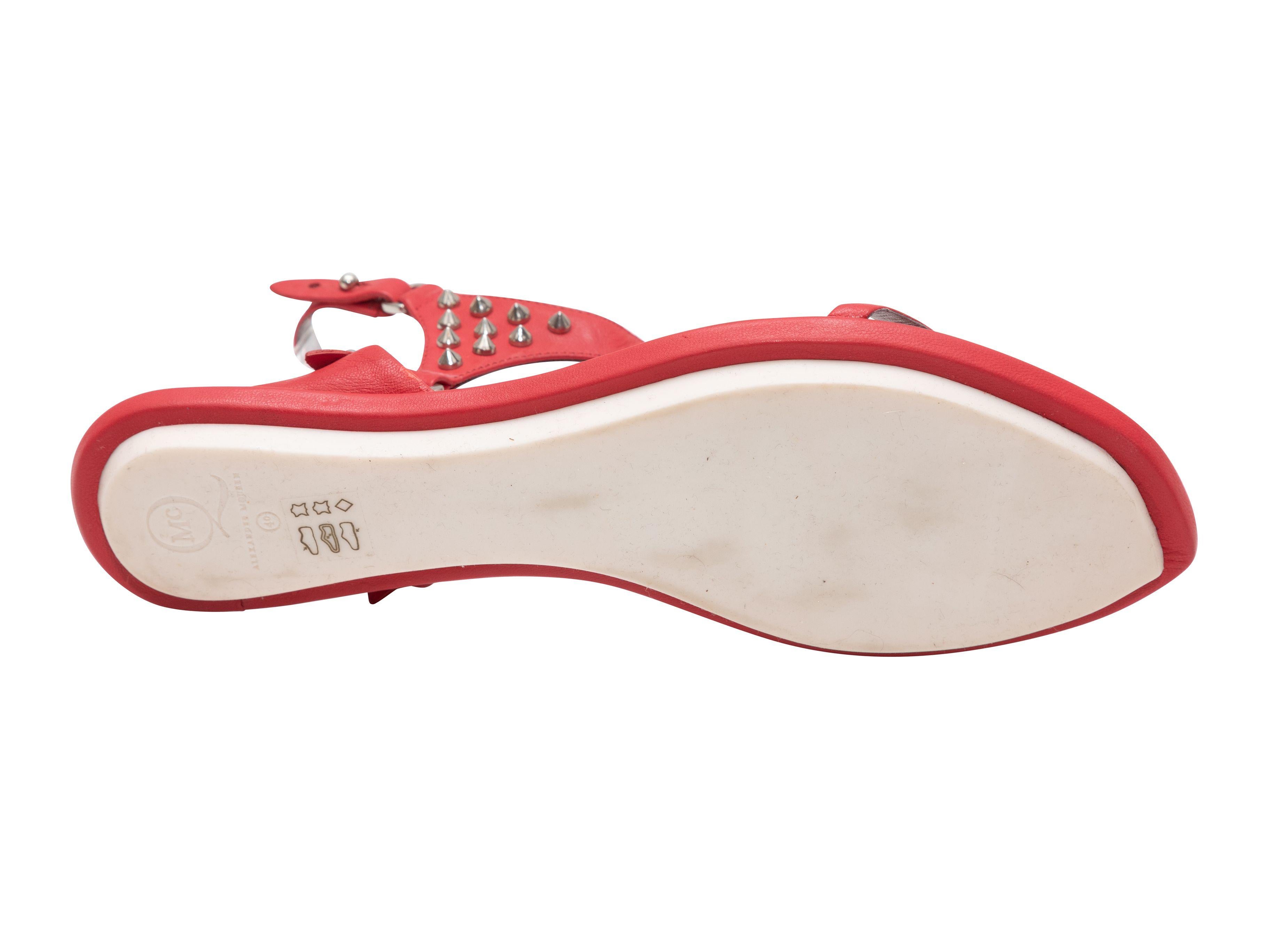 Product Details: Red leather studded flat sandals by McQ Alexander McQueen. Buckle closures at ankle straps.

Designer Size: 40
US Recommended Size: 10

Condition: Pre-owned. Very good. Light wear throughout. 
