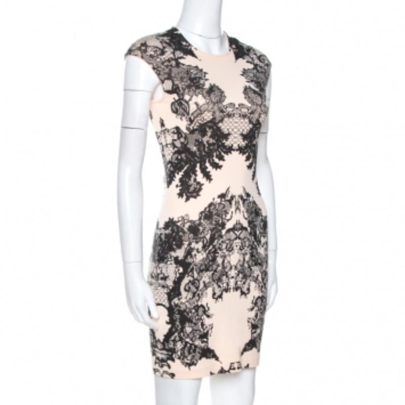 Step out in style when you wear this gorgeous dress from McQ by Alexander McQueen. Crafted from quality cotton fabric, it flaunts lovely hues of cream and black. It is styled simply and have a lovely lace print throughout. It comes with short
