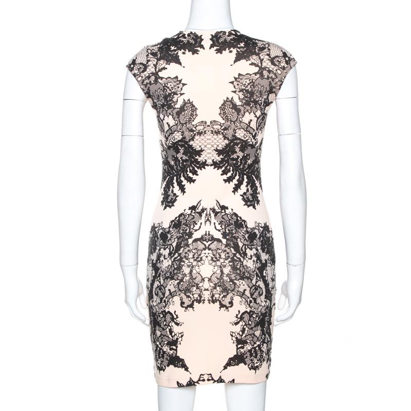 Step out in style when you wear this gorgeous dress from McQ by Alexander McQueen. Crafted from quality cotton fabric, it flaunts lovely hues of cream and black. It is styled simply and have a lovely lace print throughout. It comes with short