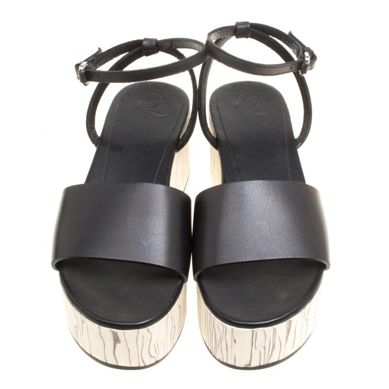 You're all set to make a fashion statement in these lovely McQ by Alexander McQueen sandals. The black sandals are crafted from leather and feature an open toe silhouette. They flaunt single vamp straps and buckled ankle wraps and come equipped with