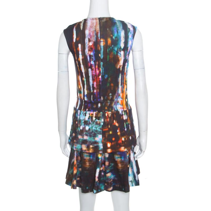 Own this chic dress from McQ by Alexander McQueen, perfect for any evening affair. Flaunting an intriguing blurry light print all over, the dress is shaped in peplum style that highlights the waistline and can be accessorized with a belt. This