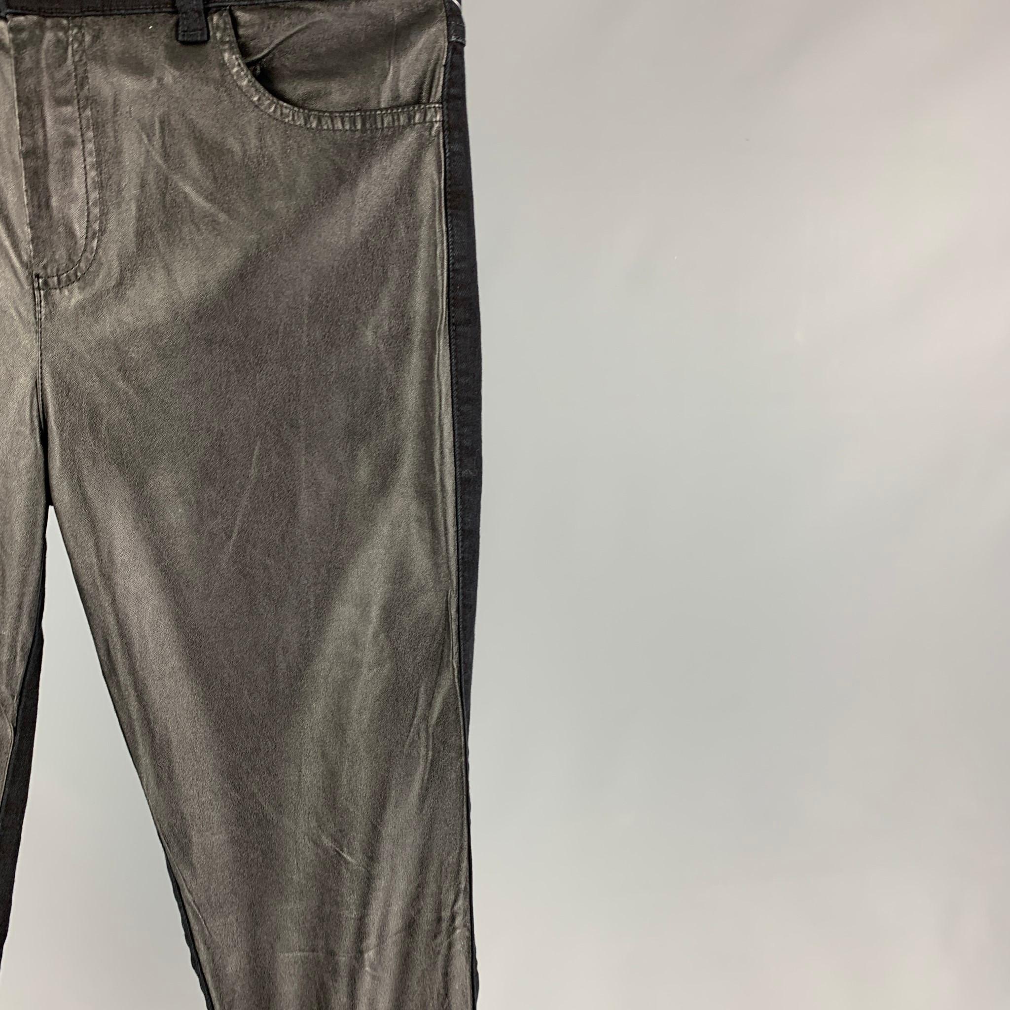 MCQ by ALEXANDER McQUEEN jeans comes in a black cotton with a faux leather panel design featuring a skinny fit, silver tone button, and a zip fly closure. Made in Italy. 

New With Tags.
Marked: 30

Measurements:

Waist: 32 in.
Rise: 11 in.
Inseam: