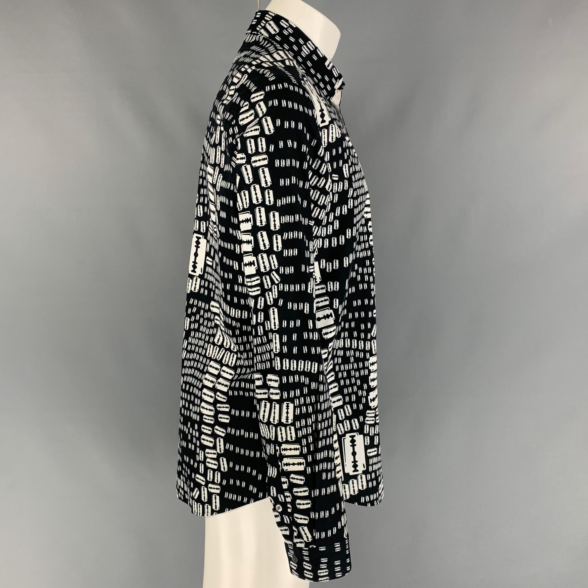 MCQ by ALEXANDER McQUEEN long sleeve shirt comes in a black & white razor blade print cotton featuring a spread collar and a button up closure. 

Excellent Pre-Owned Condition.
Marked: 52

Measurements:

Shoulder: 18 in.
Chest: 42 in.
Sleeve: 26.5