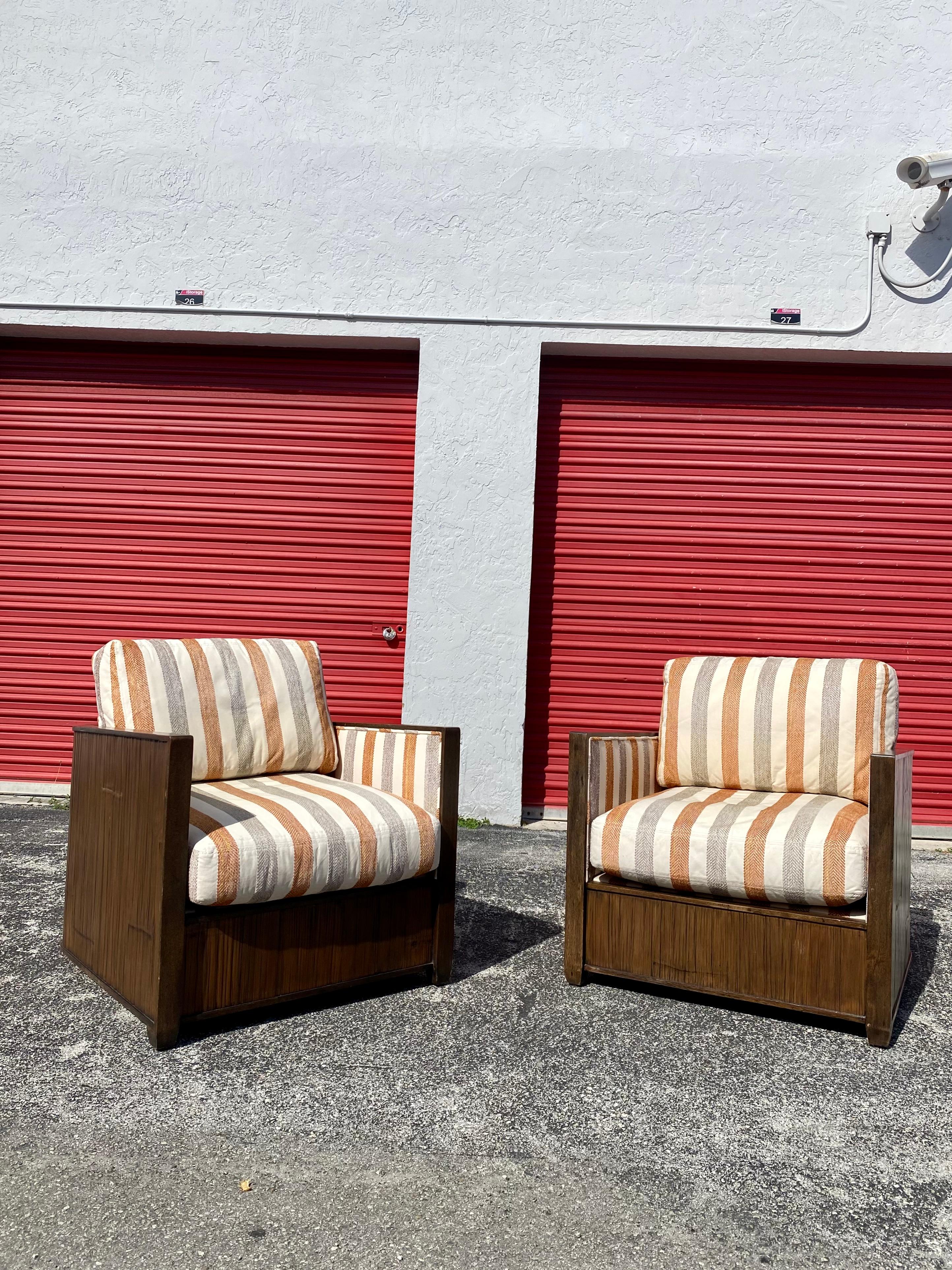 Extremely rare! Dramatic pair of organic wood case barrel back club chairs by McGuire. The chairs feature a slight barrel form rattan and wood frame. Fully upholstered with thick filled cushions for ultimate comfort. Textured wood case designed.