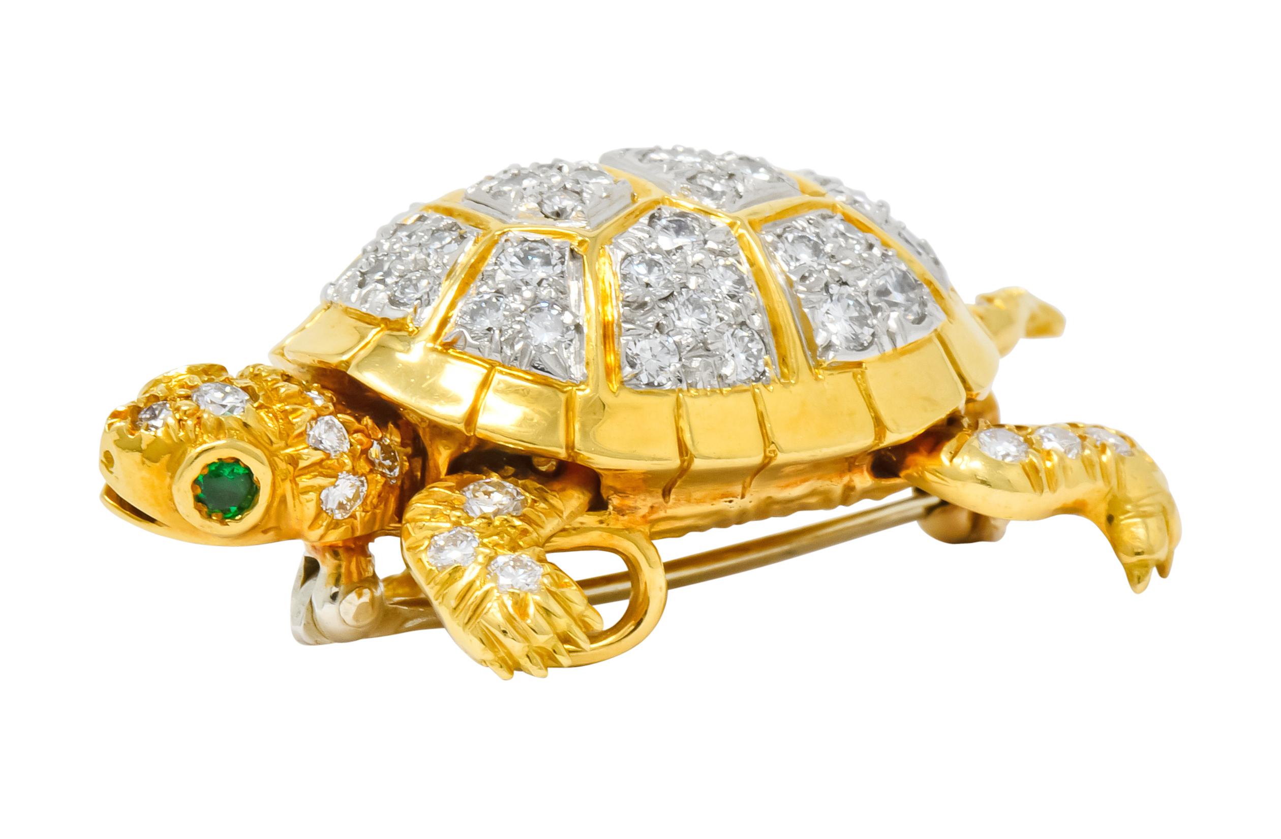 Pendant brooch designed as a turtle featuring articulated limbs and round cut emerald accents as eyes

Gold limbs and platinum-topped shell are bead set throughout by round brilliant cut diamonds weighing approximately 2.20 carats total; G/H color