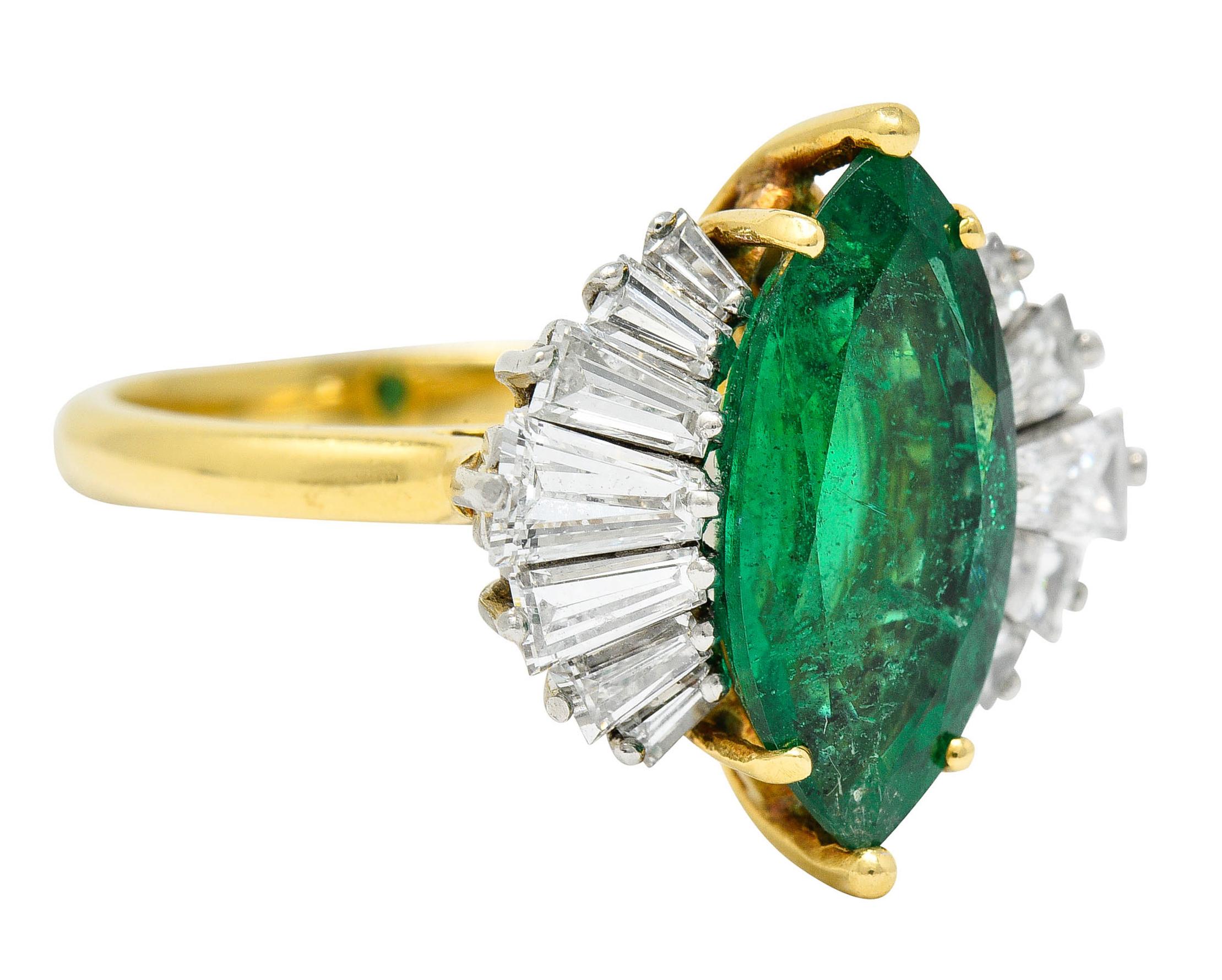 Centering a marquise cut Zambian emerald that weighs approximately 2.45 carats

Semi-transparent and bright green in color with moderate clarity enhancement (F2)

Flanked by a half halo of tapered baguette cut diamonds, set in platinum

Weighing in