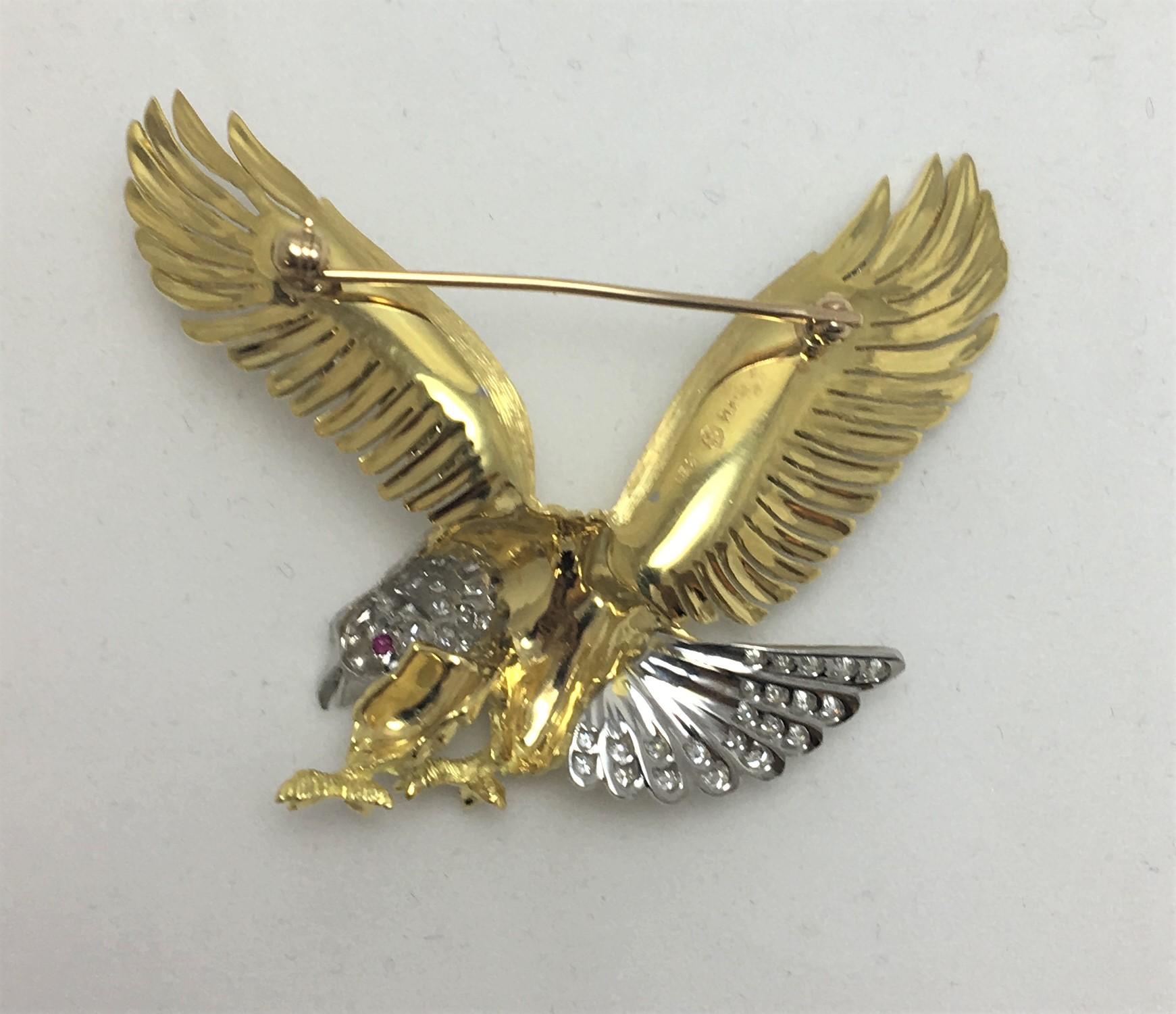 Beautiful Handcrafted McTieque 18K Yellow Gold and Platinum Eagle Brooch

100 full-cut round brilliant diamonds measuring approximately 1.3-1.8mm each
Approximately 2.00 Carat Total Weight
1 Round Ruby as 