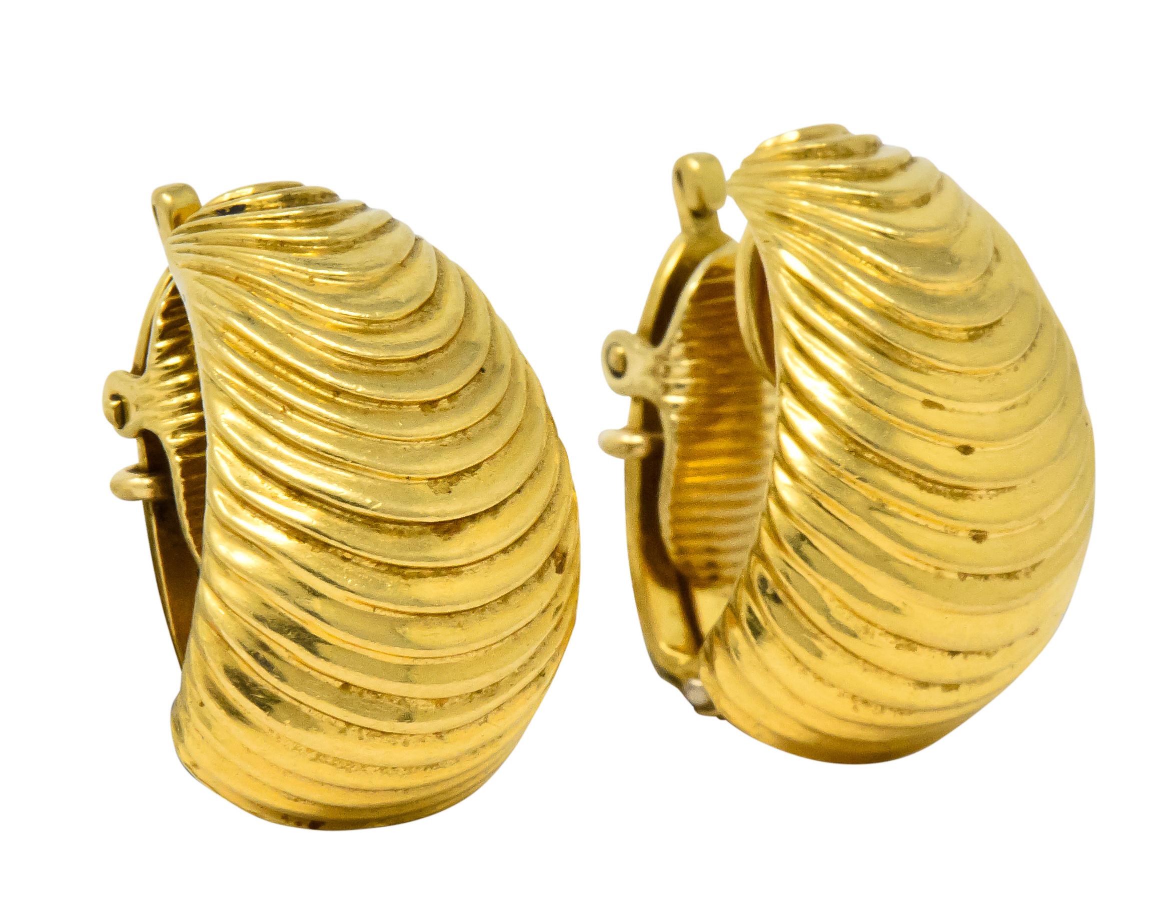 Designed as tapered half hoops with a cascading ribbed texture

Completed by hinged clip back

Maker's mark for McTiegue

Stamped 750 for 18 karat gold

Circa 1960's

Measures: 1 1/4 x 5/8 inches

Total weight: 10.5 grams

Flowing. Bold. Appealing.
