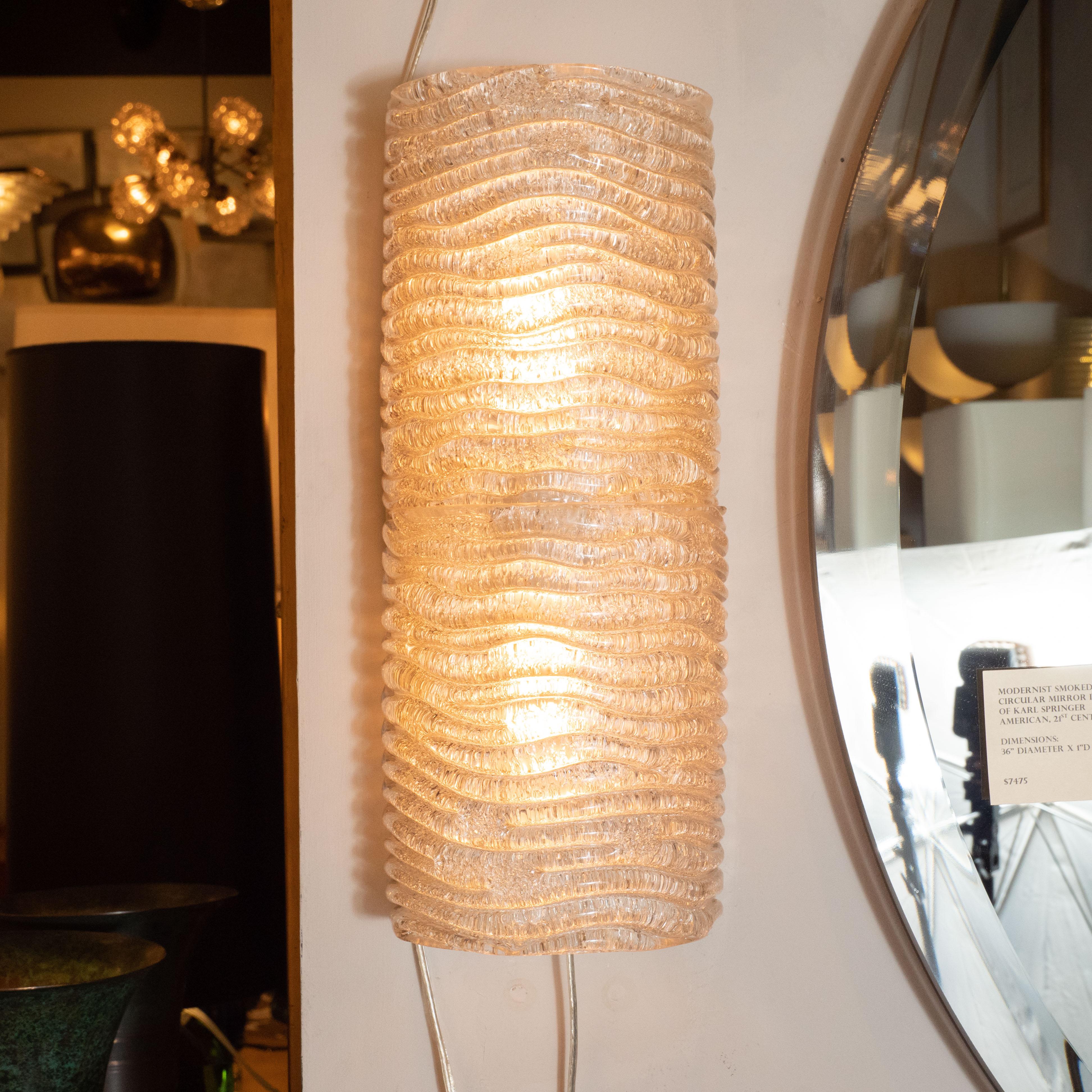 This pair of Mid-Century Modern sconces were hand blown in Italy circa 1950. Each sconce features tight rows of arched, organically shaped textured glass bands. The dynamic rhythm embedded in the glass provides an elegant contrast to the overall
