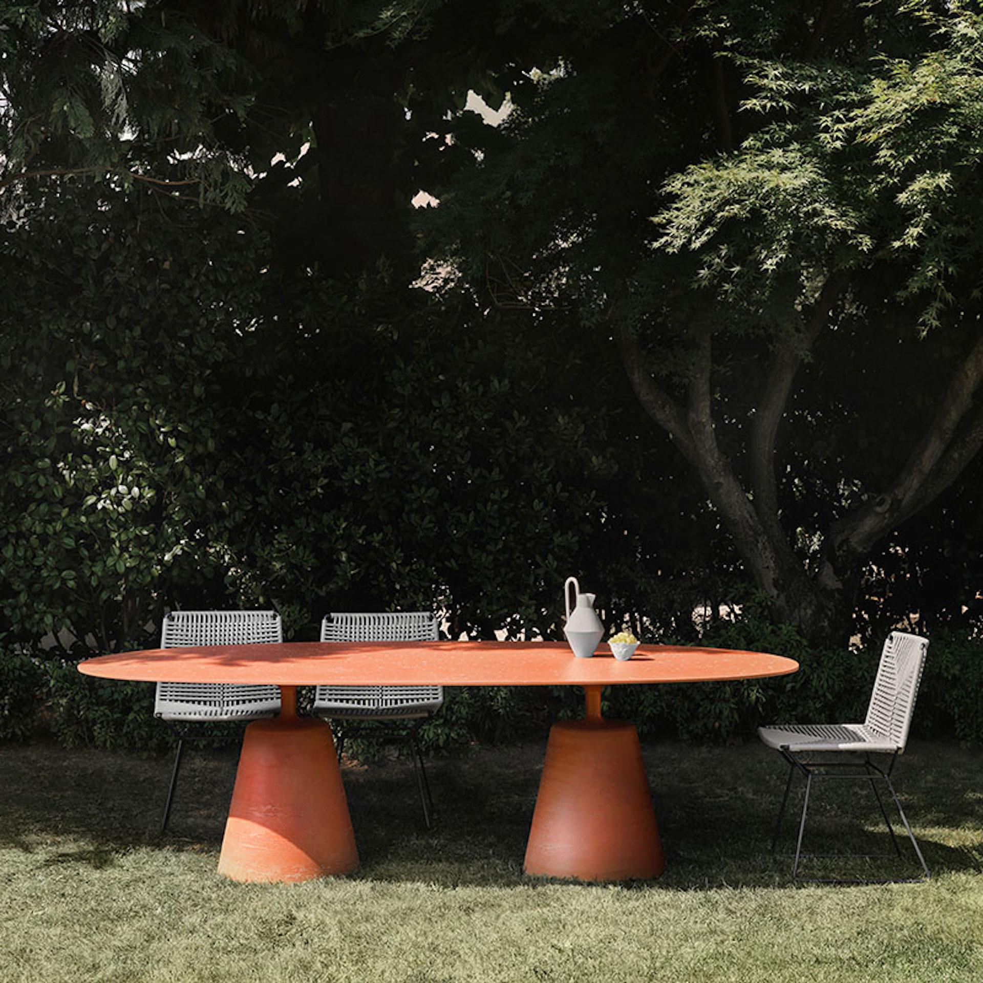 Rock Table is a family of indoor and outdoor tables with an elegant, fluid silhouette, characterised by a solid central conical base and a thin top that appears to float. The new model features a top with an unusual and interesting shape: a