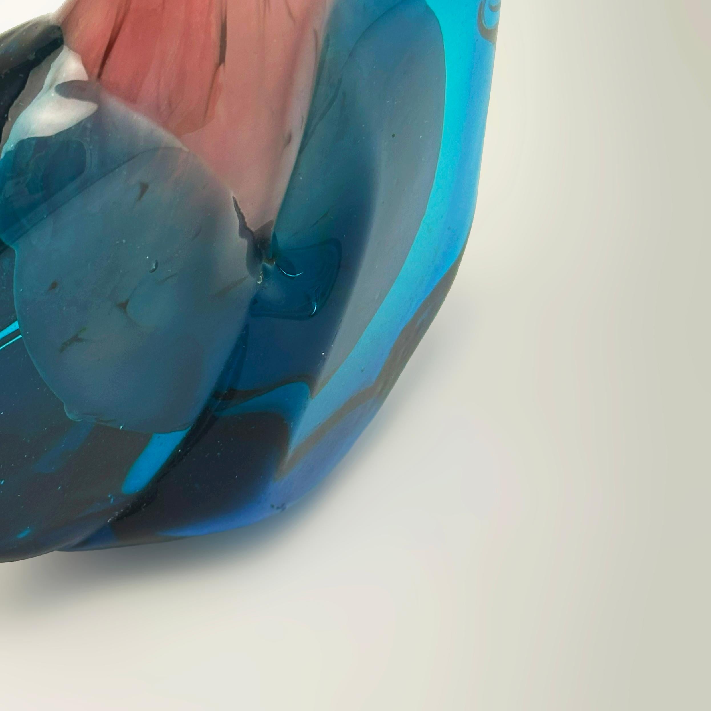 Handcrafted in Malta in the 1970s, this Mdina Glass solifleur vase exemplifies the studio’s bold and experimental approach. Sometimes referred to as the axe head  vase, the form is defined by its angular hexagonal body and slim tapering neck.

The
