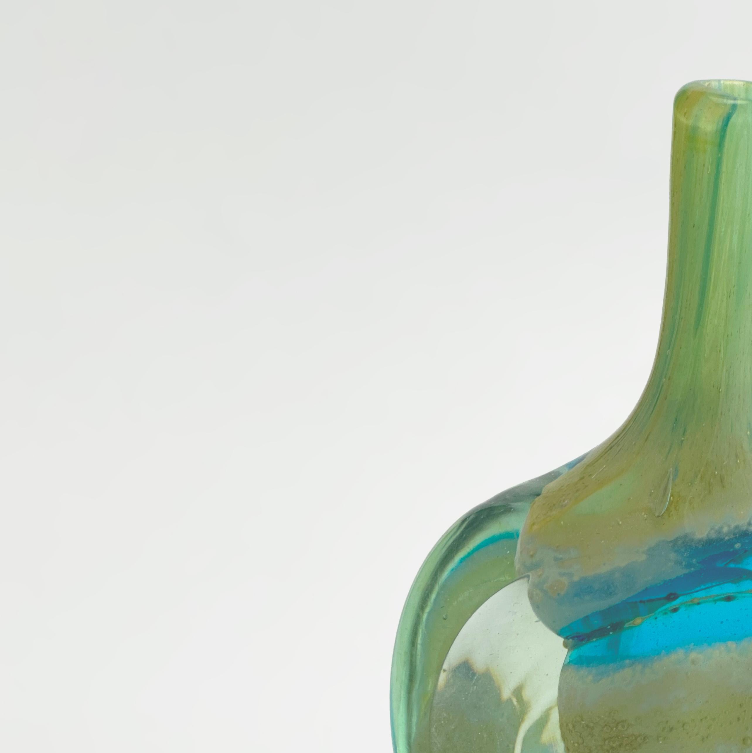 An evocative piece of mid-century Maltese art glass, this Mdina Glass solifleur vase—often referred to as the “Lollipop Vase” or “Cut Ice Vase”—was handblown on the island of Malta in the late 1970s. Its form and colourway embody Mdina’s early