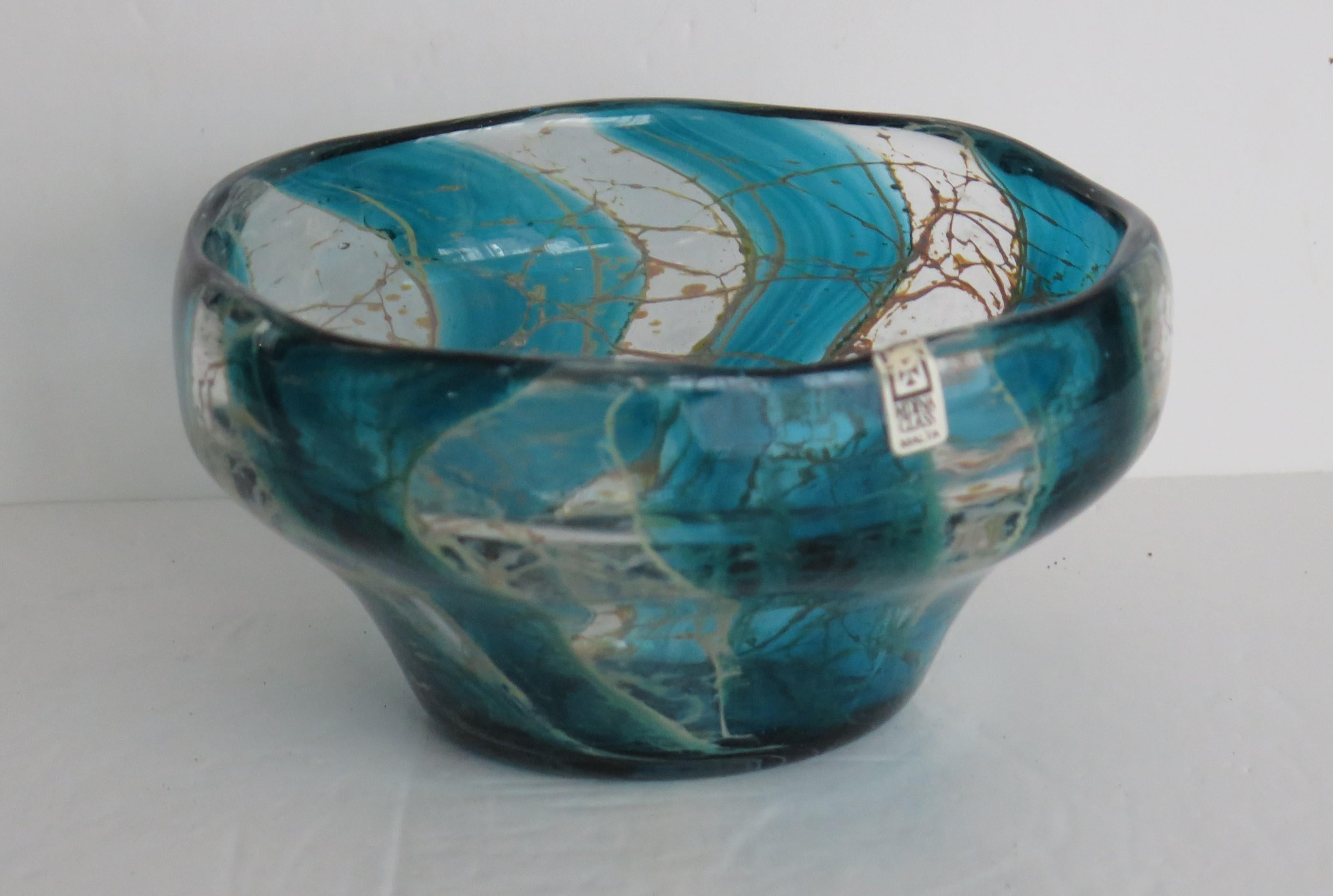 This is a beautiful Art Glass bowl made by Mdina glass, Malta during the 1970's

This bowl has a lovely shape, hand crafted in all aspects and decorated in what we think is the Crystal Blue stripe pattern. It has the original label stuck on the