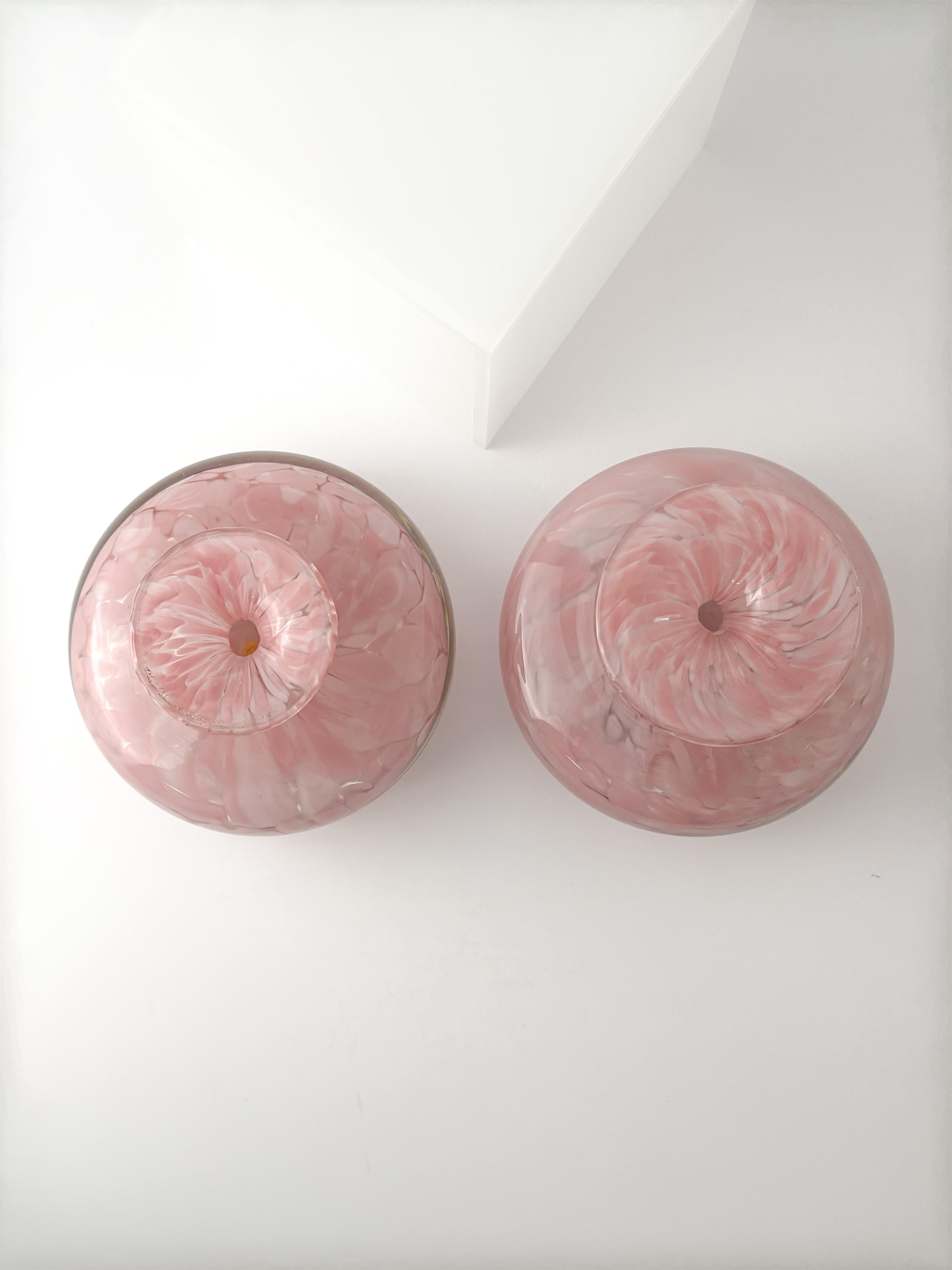 A matching pair of small pink glass bottle vases by Mdina Glass, handcrafted in Malta in the 1980s.

In good condition for their age and use, each vase measures 8 cm in diameter and 6 cm in height. A lovely example of vintage Mdina glass, perfect