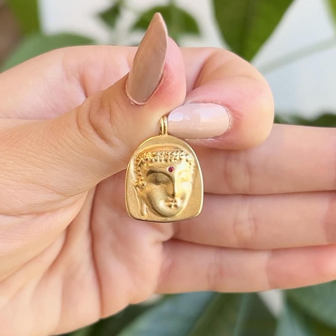 One Me & Ro Ruby 18 Karat Yellow Gold Buddha Pendant. Featuring one round ruby of approximately 0.10 carat. Crafted in 18 karat yellow gold, signed Me & Ro. Circa 2010. 

About this Item: Become illuminated with the wisdom of the symbolism in this