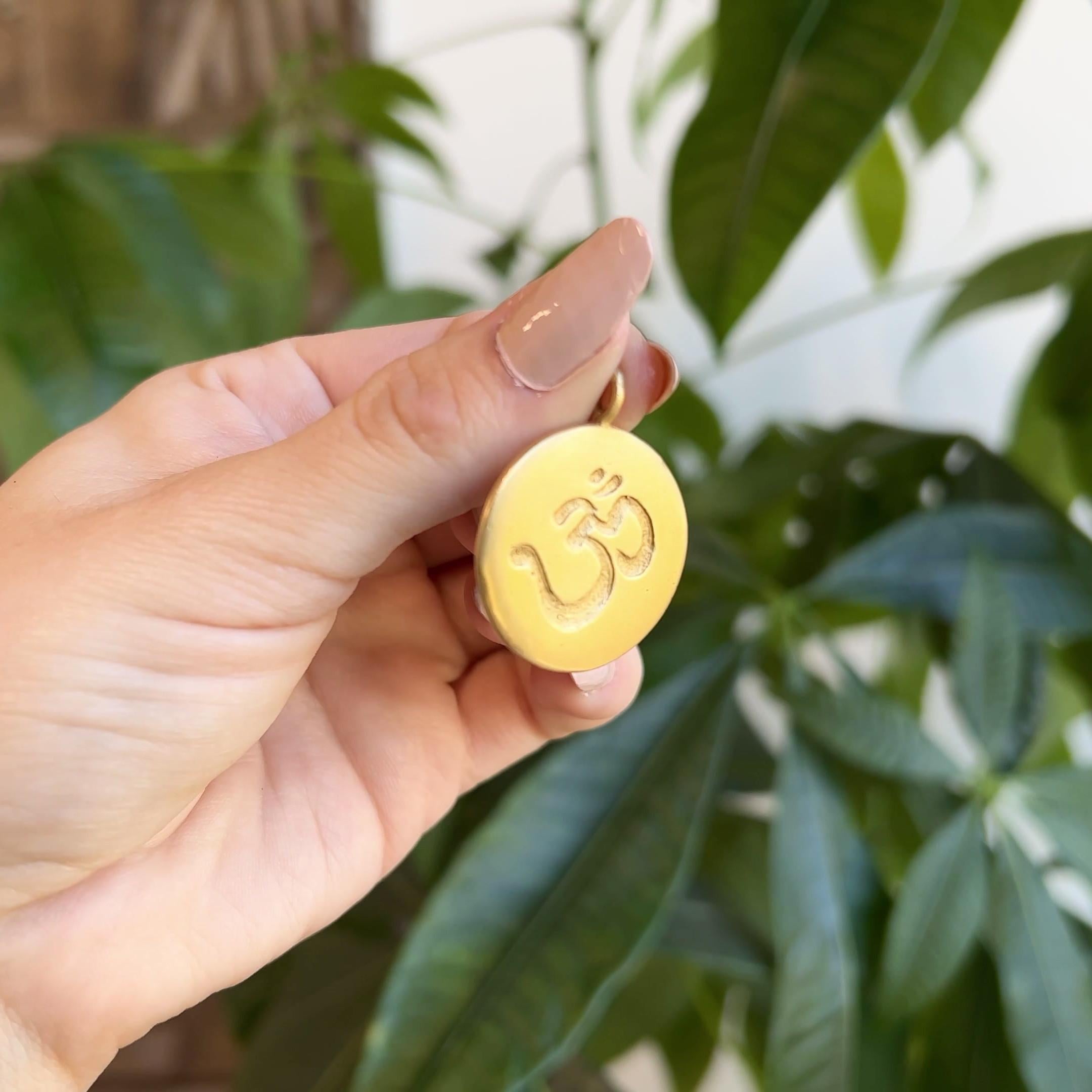 One Me & Ro Yellow Gold OM Disk Pendant. Crafted in 14 karat yellow gold signed Me & Ro. Circa 2010.

About this Item: Embody the meaning of OM when you wear this Me & Ro 