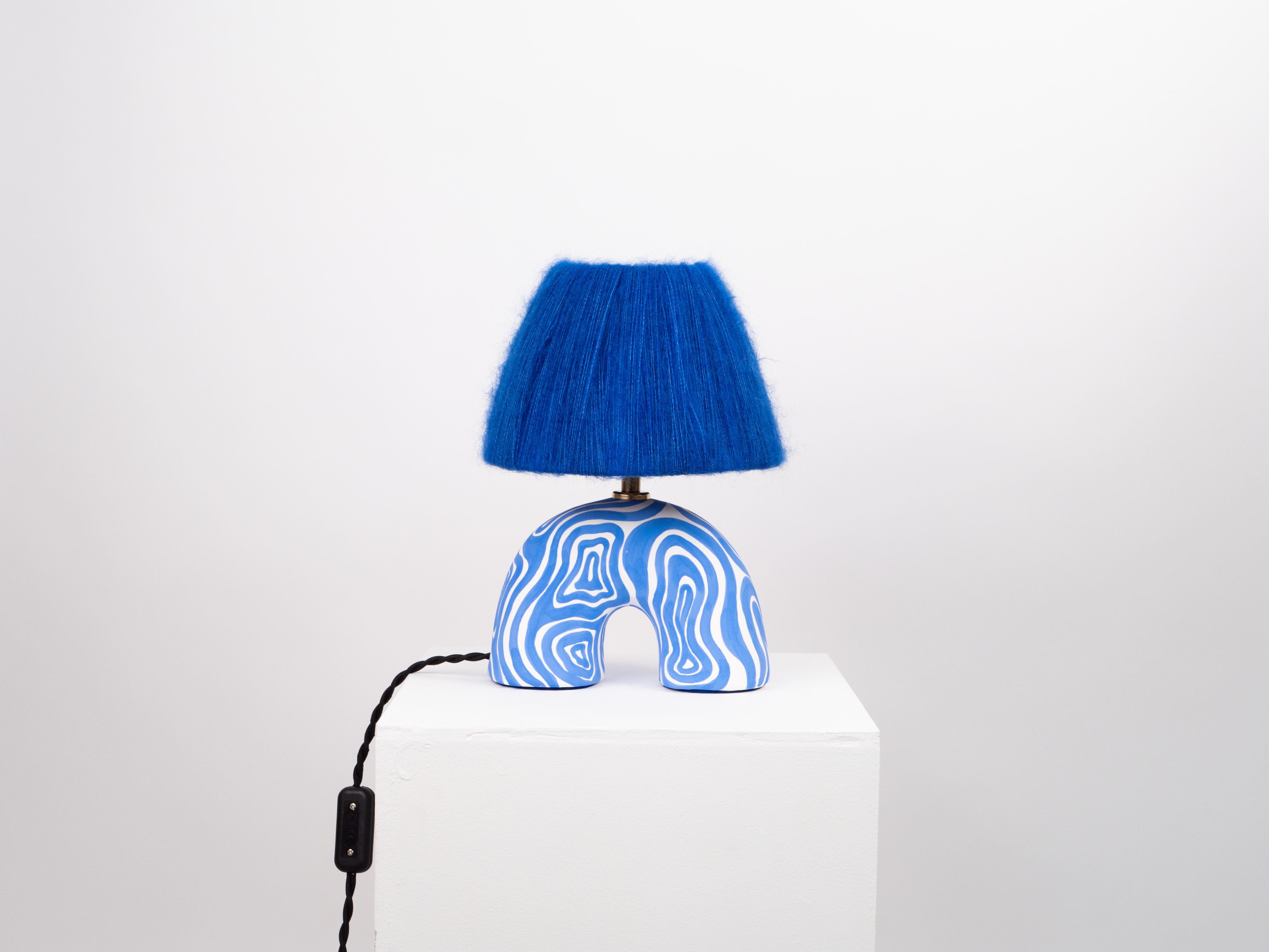 White and blue wave pattern with a matte finish and blue mohair shade 

Estimated processing time is 2 weeks from order confirmation

Pictured with a Mini Globe LED E27 Bulb. Bulb not included

To pair this base with a shade in an alternative colour