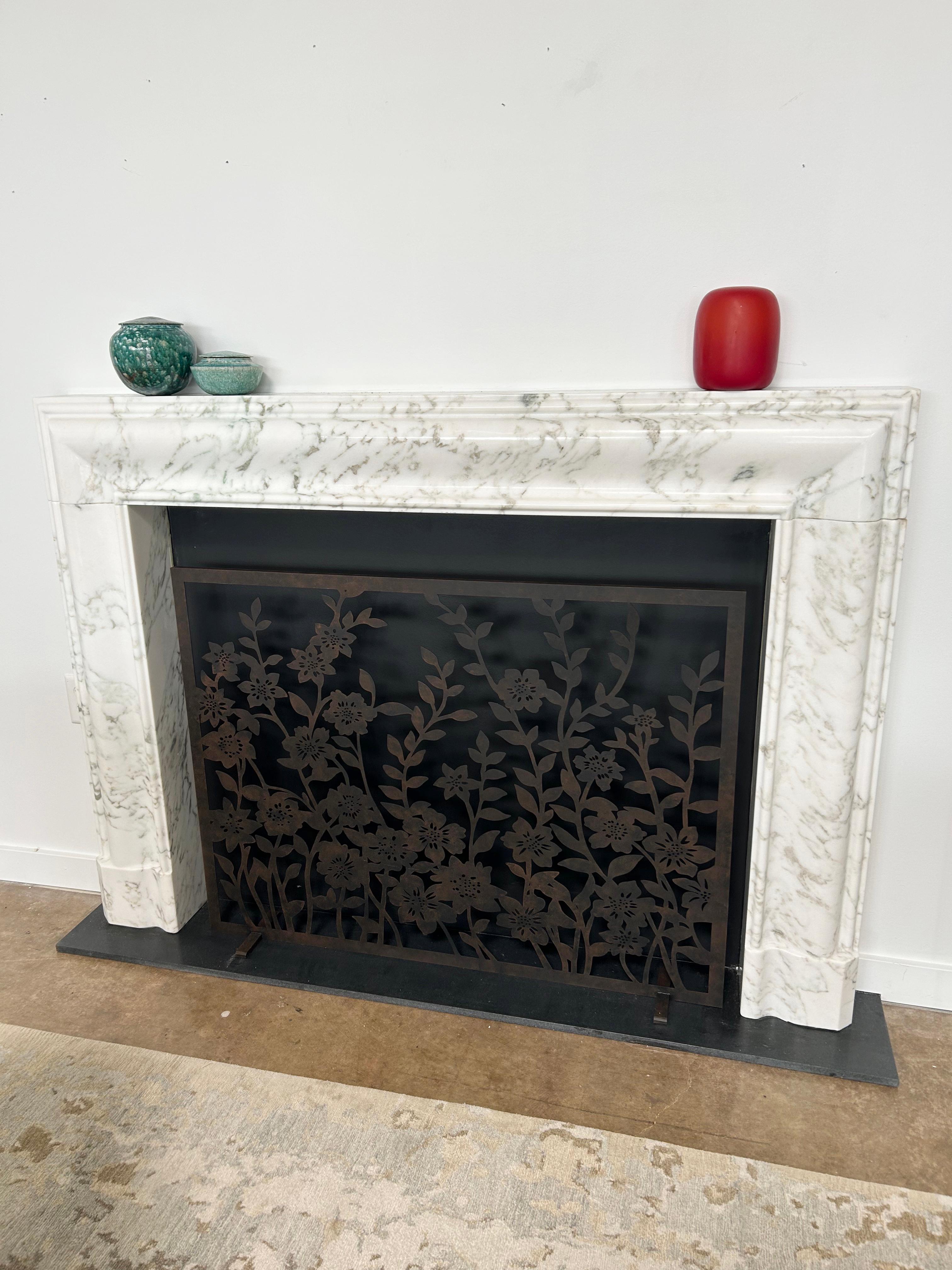 A romantic tangle of hand-cut metal blooms creates a soft yet structured composition, where delicate petals and graceful vines intertwine in quiet harmony. The organic modern Meadow Fireplace Screen brings both decorative elegance and functional