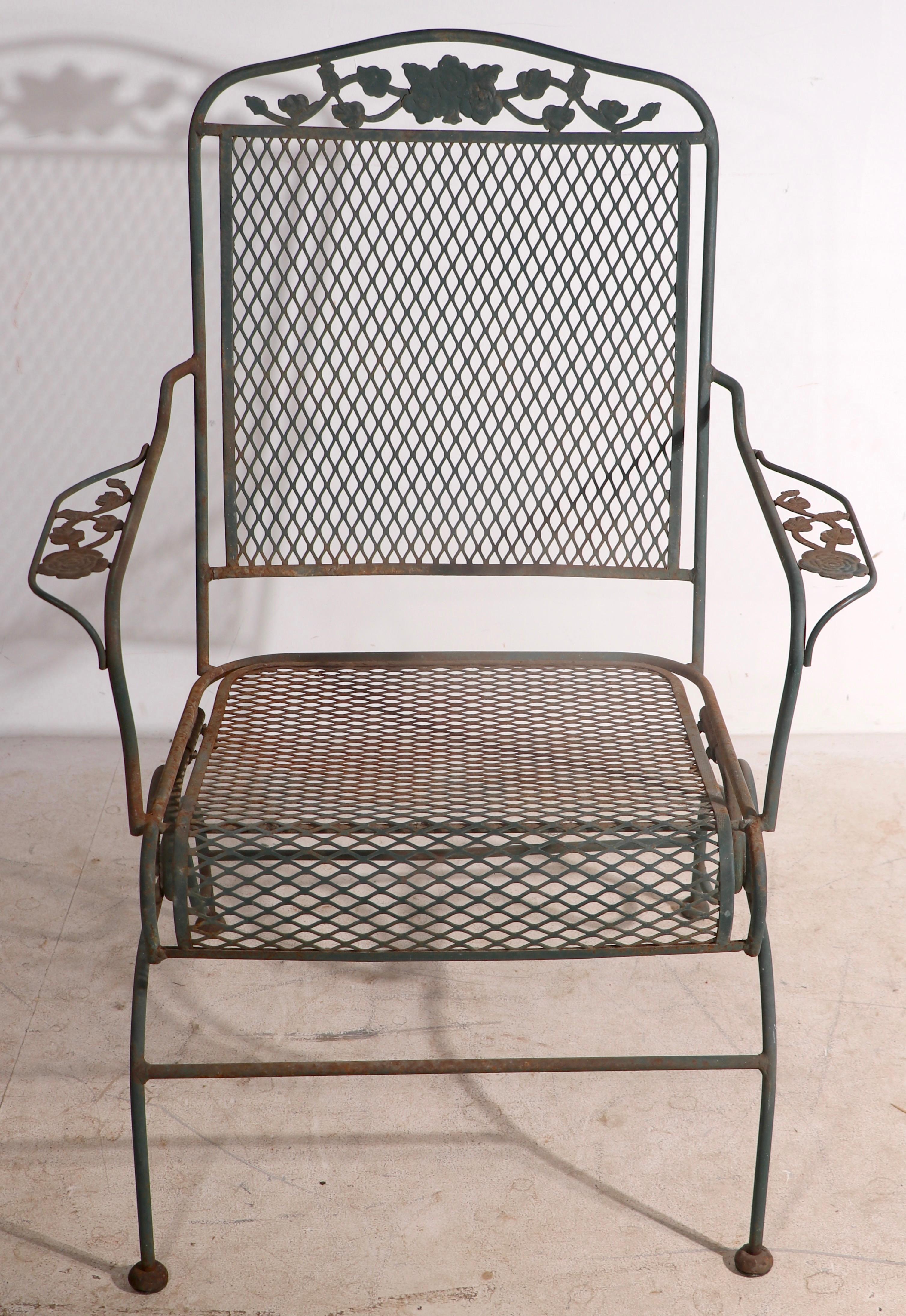 Wrought iron and metal mesh spring seat lounge chair by Meadowcraft, in the Dogwood pattern, circa 1950 - 1960's. The chair is in very good, original estate condition, showing only light cosmetic wear to finish, normal and consistent with age.