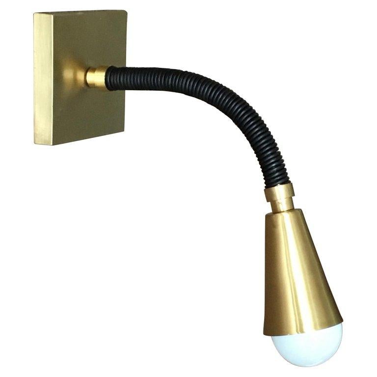 Add color and flexibility to any room with the Meander One Arm Reading Light, an adjustable wall-mounted light fixture, with flexible leather wrapped arm. 
Shown here in orange leather, Brushed Brass cone shade, optional switch on square backing