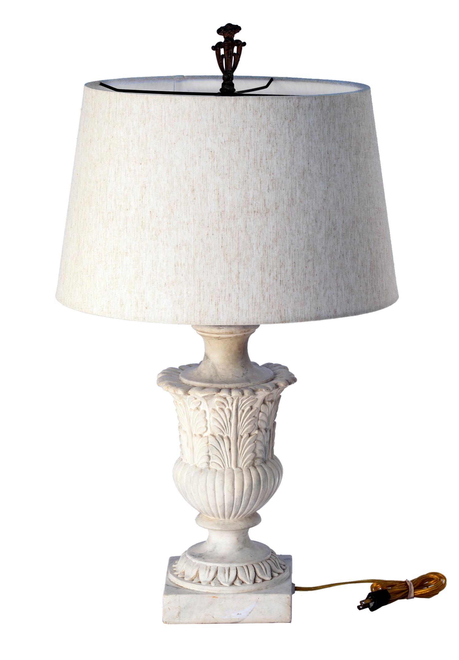 This lamp, in the neoclassical style was created using casting stone material. Ornate & heavy faux marble neoclassical urn. 
The base has an intricate leaf pattern, with a fluted body which sits atop the square base which has classical repeat
