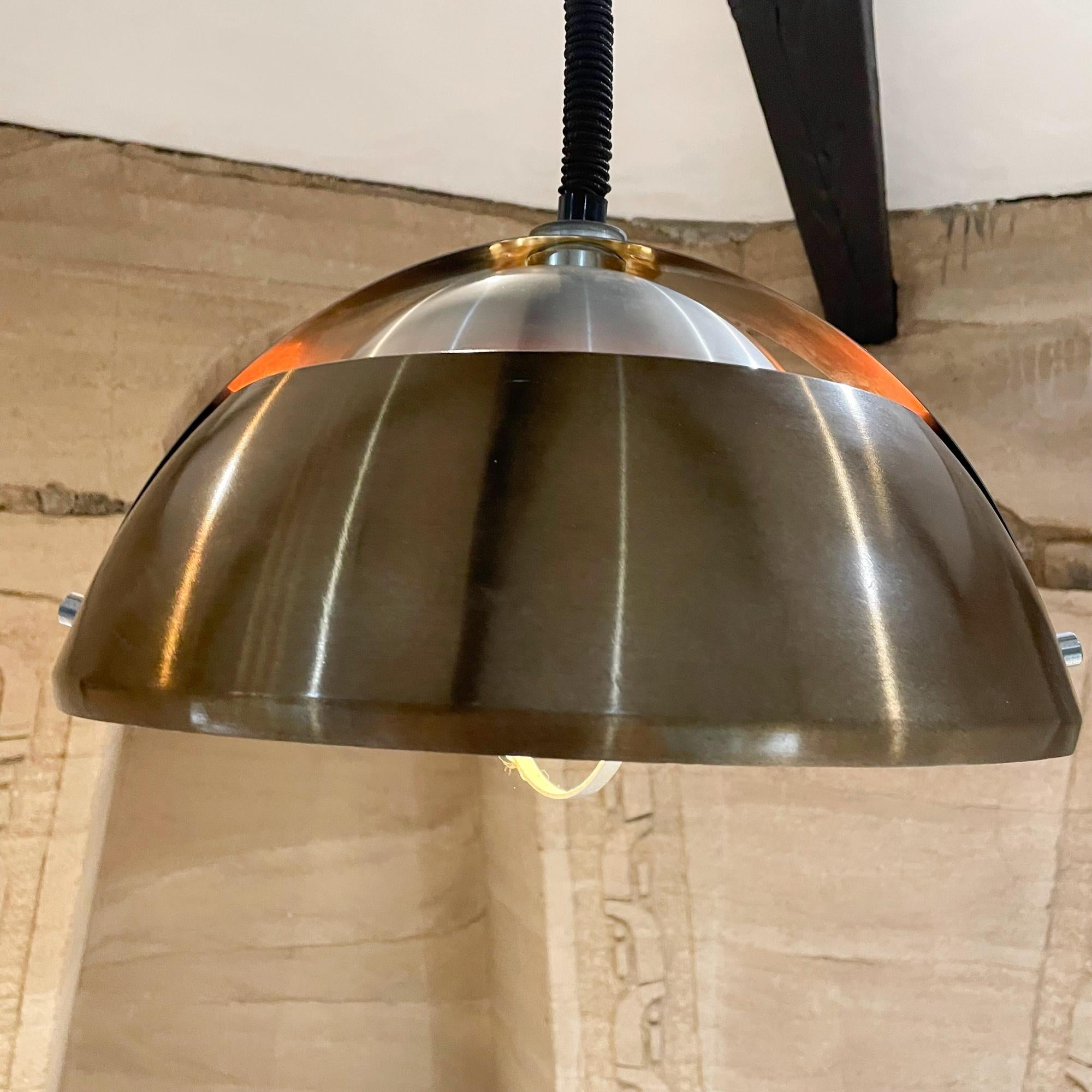 Meblo Guzzini Space Age pendant lamp in brown orange & stainless chrome multi layered shades.
Made Italy 1970s
Unmarked. In the design style of Meblo and Harvey Guzzini.
Measures: 15 diameter x 9 tall 27 tall and 63.5 long fully extended
Style
