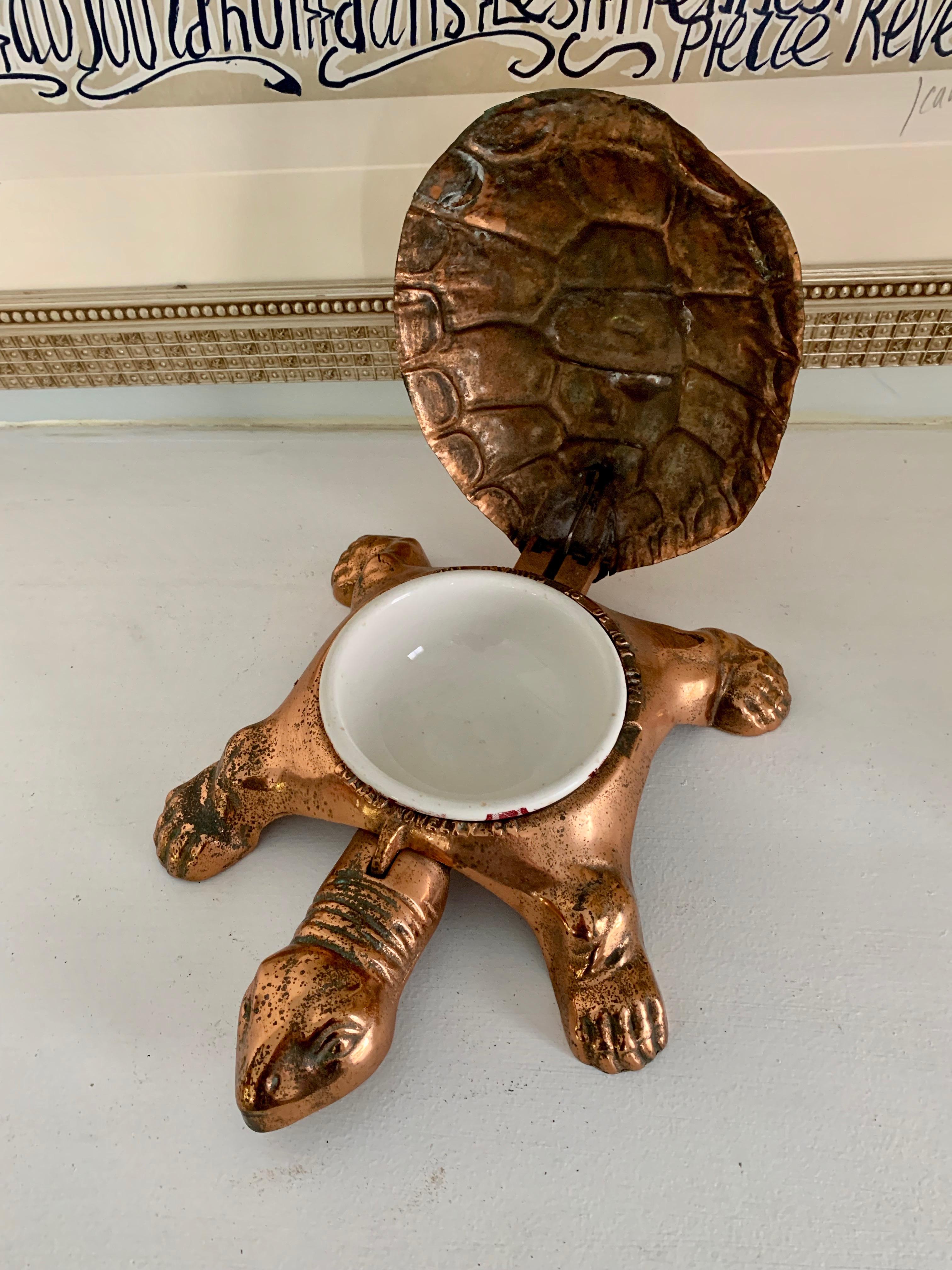 A copper over cast iron turtle with a unique mechanical head, that stepped on, opens the back... this was patent 1891 and marked as such - the piece was designed to be a cuspidor, spittoon, however makes a unique and lovely pet dish - open for