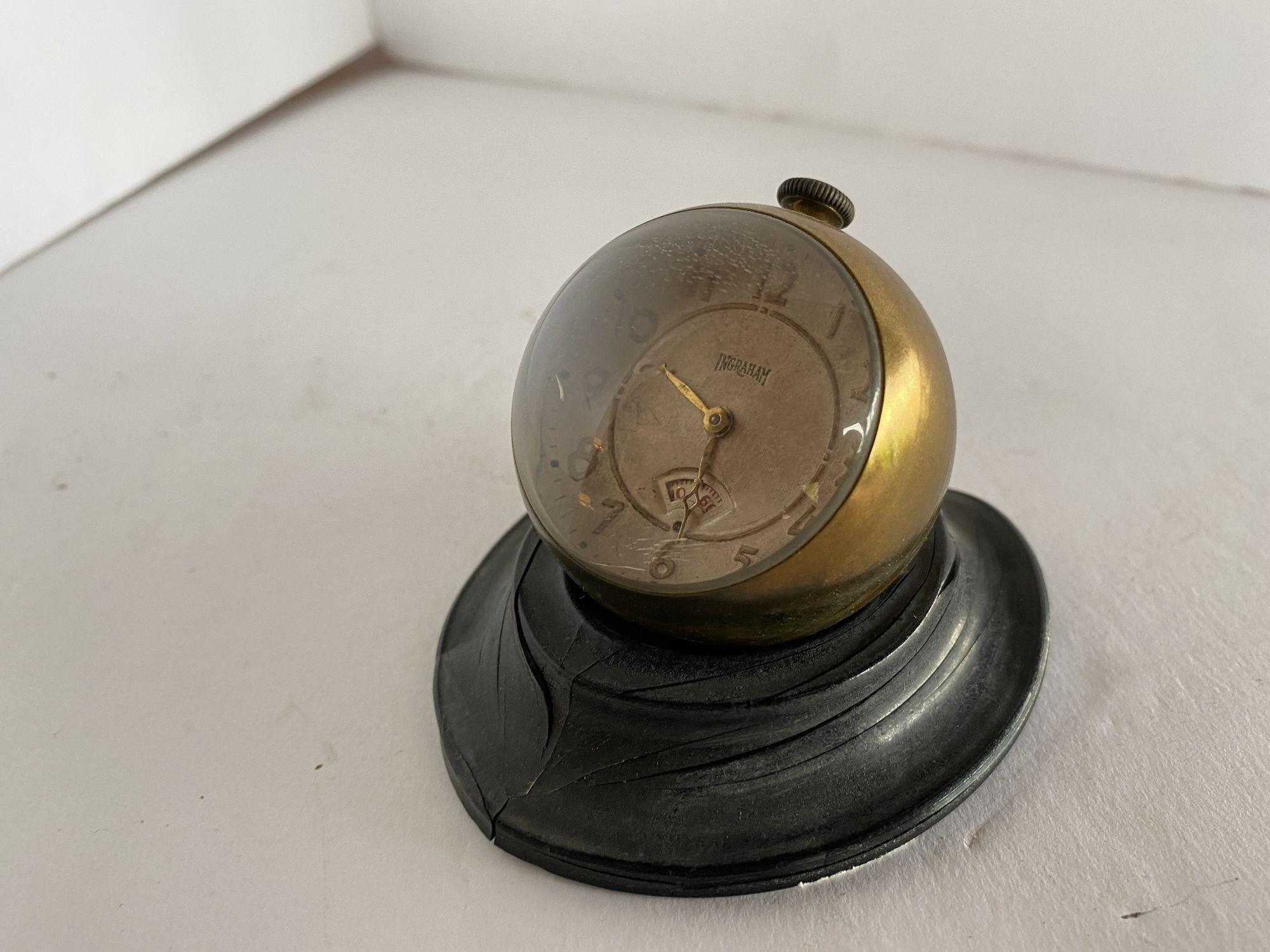This is a little 30-hr. clock that has a face that magnifies the numbers. It has a second revolving unit. Mechanical pocket watch design ball clock, wind the winding knob for running the small clock. Pull up the winding knob gently for dialing the