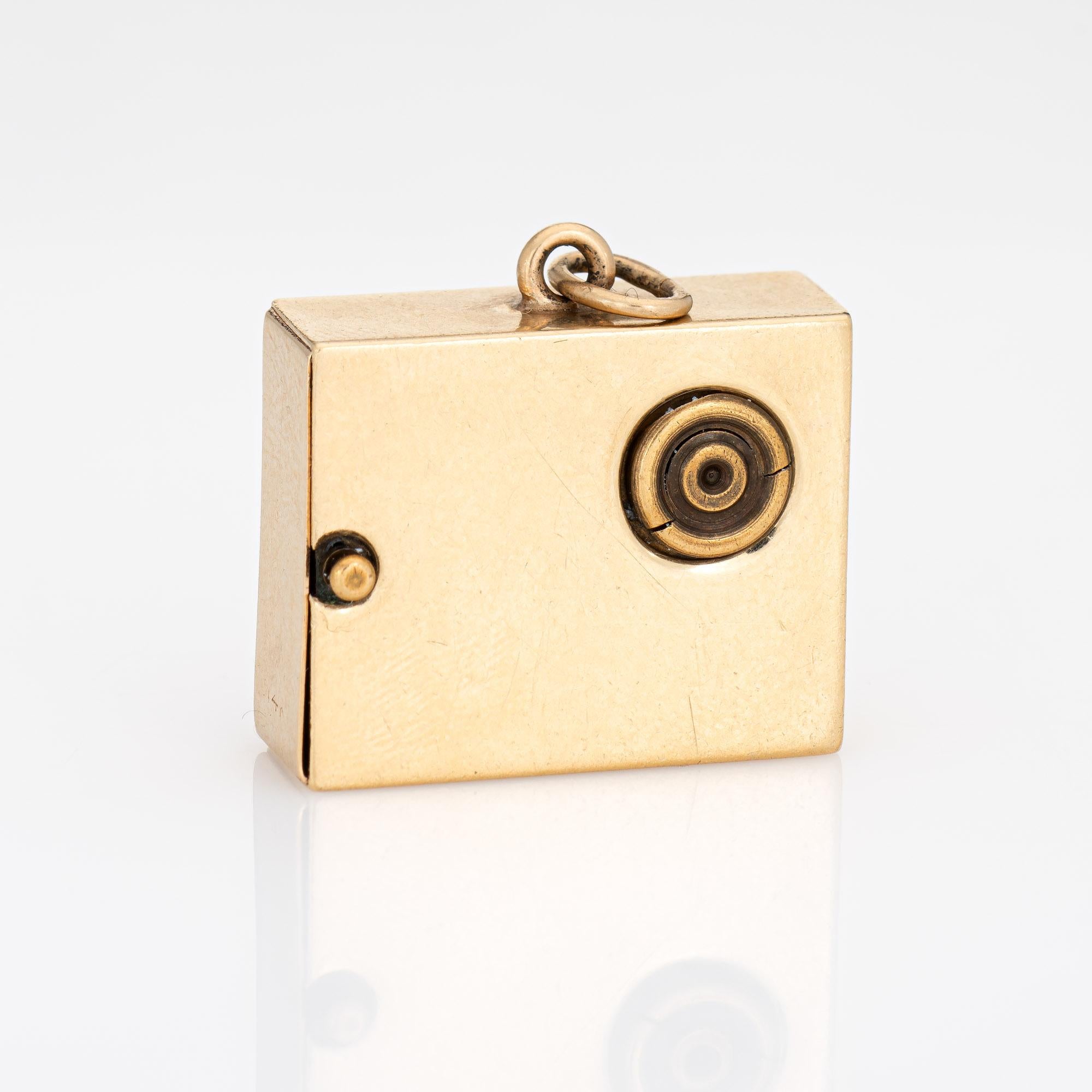 Finely detailed vintage mechanical music box charm crafted in 14k yellow gold (circa 1950s to 1960s).  

The distinct gemstone set music box charm features a florentine finish with a music sheet and applied Treble Clef. The back of the charm is