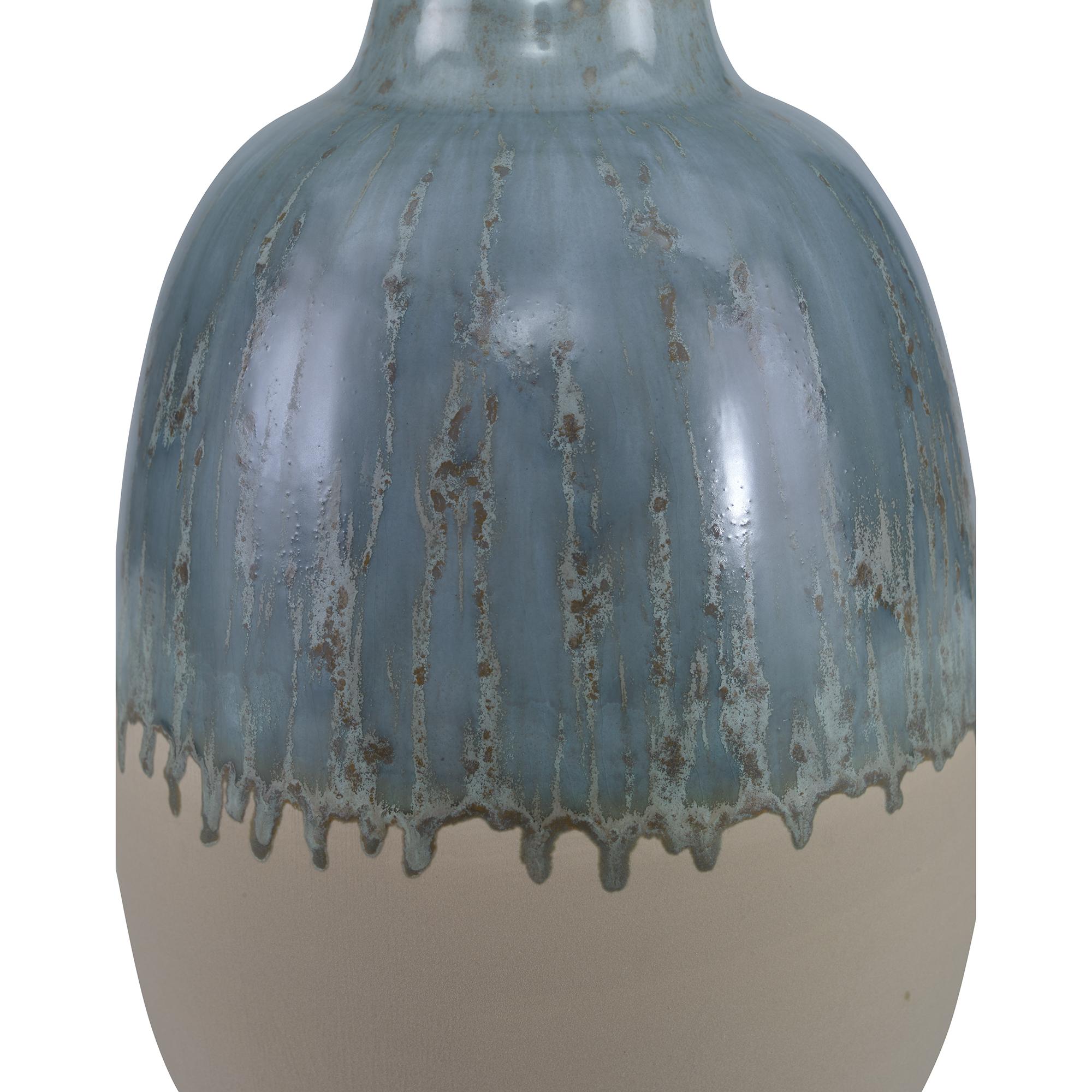An earthenware vase featuring a reactive green glaze. Due to the nature of the glaze, each vase is to be considered unique.
 