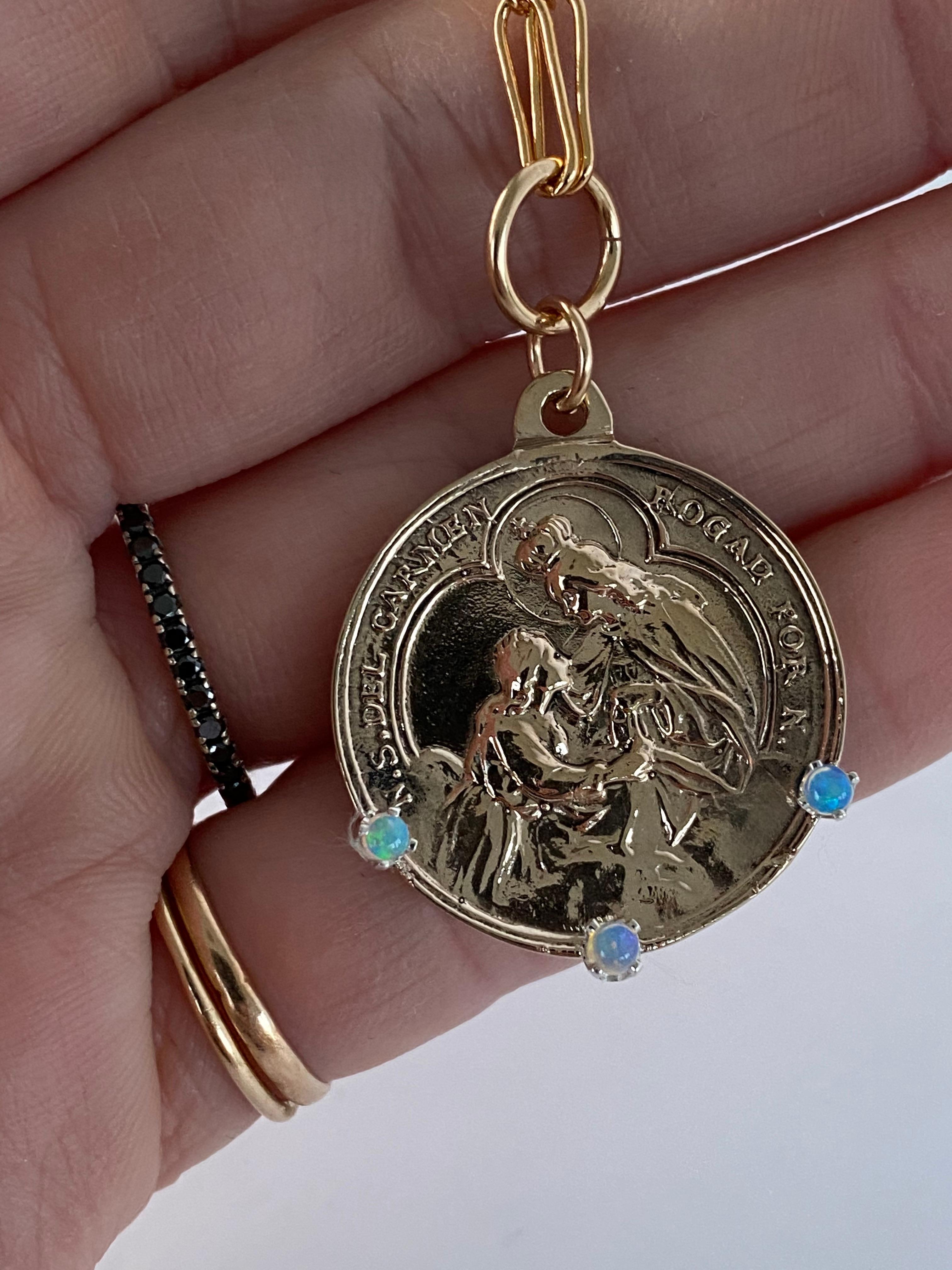 Medal Chain Necklace Opal Virgin Mary Pendant 

Designer: J Dauphin
Material: Gold filled Chain, Bronze Medal
Gem: 3 Opals

Exclusive piece with Virgin Mary pendant with 3 Opals. The Chain is 24' long but can be made shorter or longer on