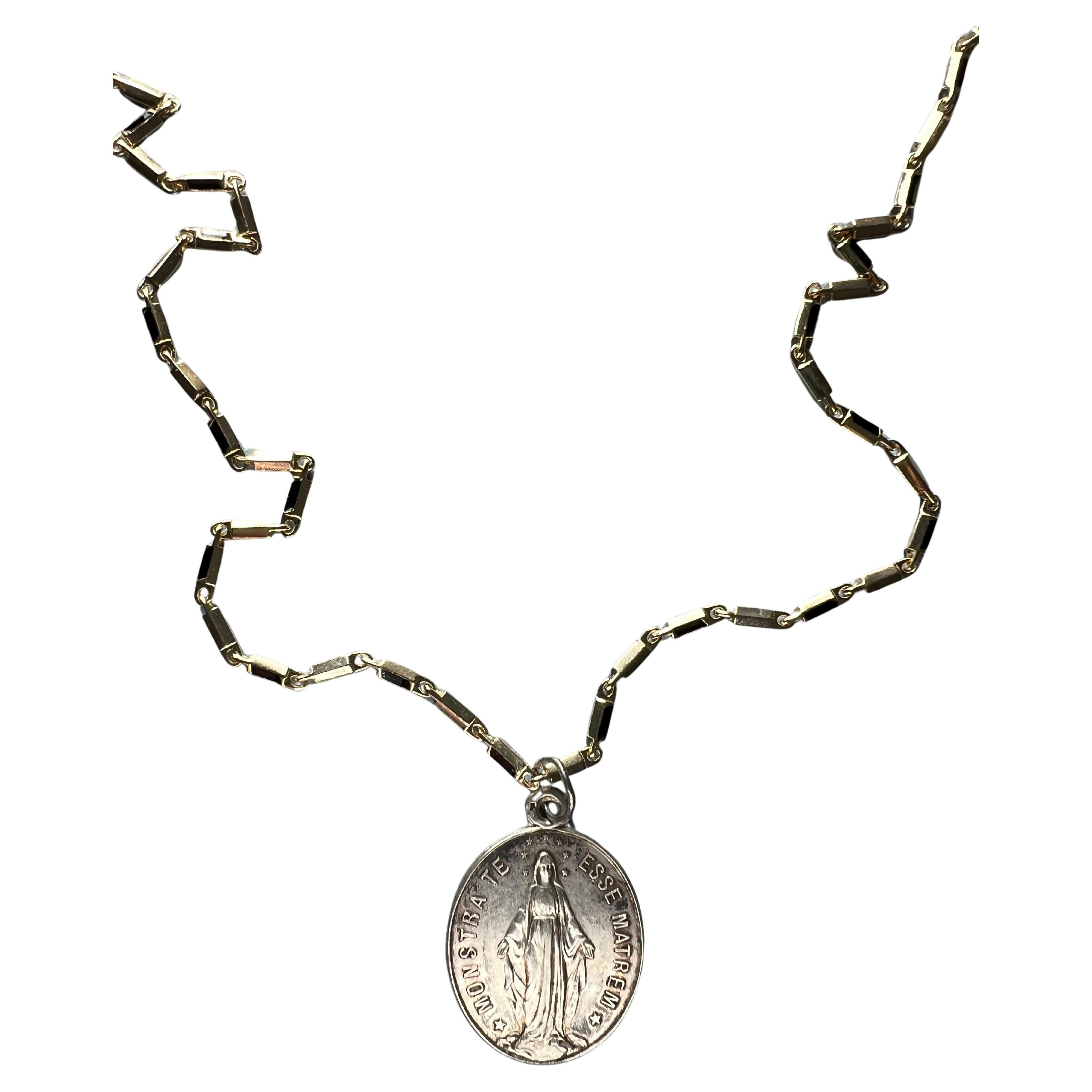 Medal Virgin Mary Chain Necklace

Vintage Medal, Designer of Chain : J Dauphin
14k Gold Plated Brass Chain and Silver Medal 

Symbols or medals can become a powerful tool in our arsenal for the spiritual. 
Since ancient times spiritual pendants,