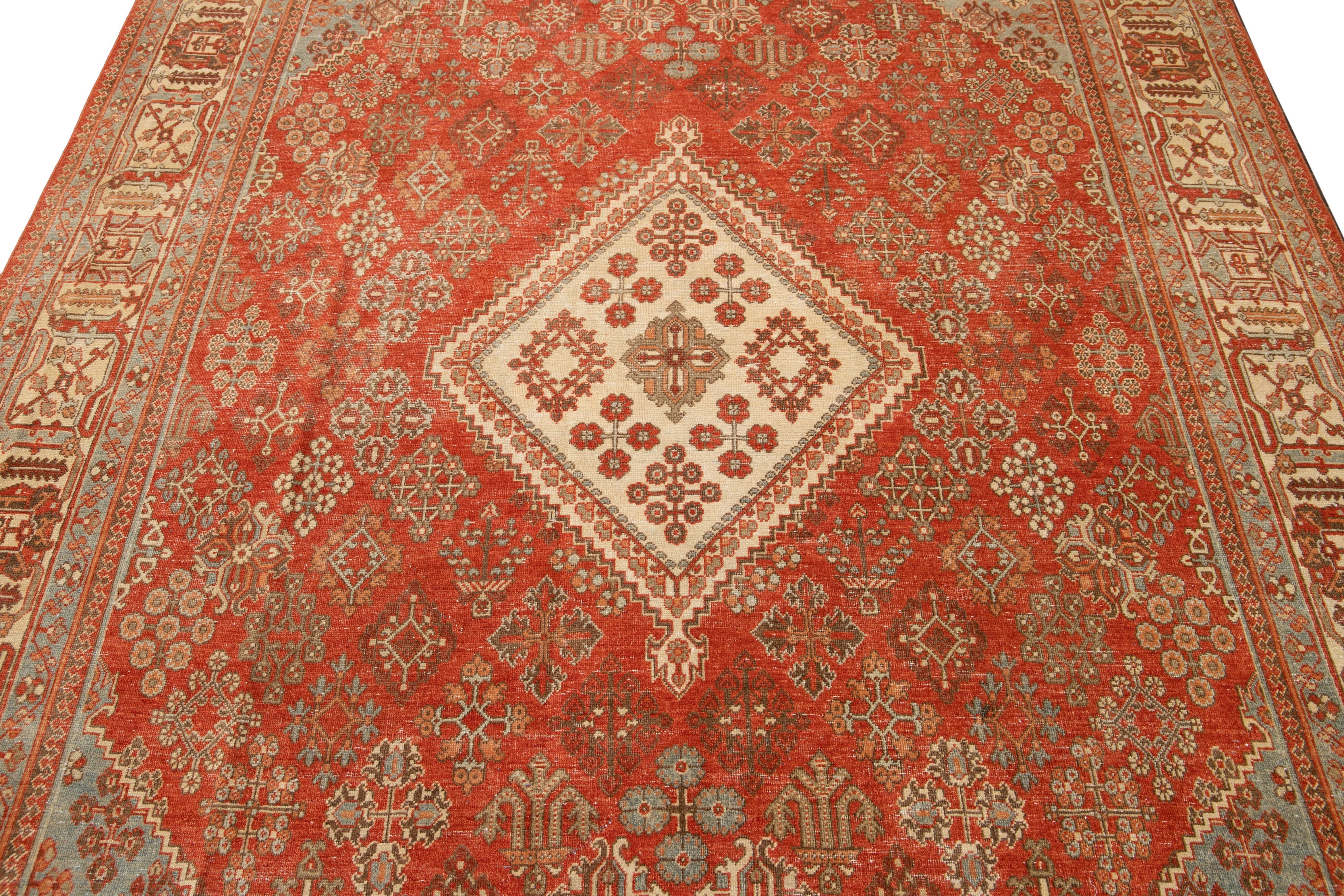 This Josheghan Persian wool rug boasts a captivating antique allure. Meticulously hand-knotted using premium quality wool, it features an alluring orange-rust field with striking multi-color accents arranged in a mesmerizing all-over multi-medallion
